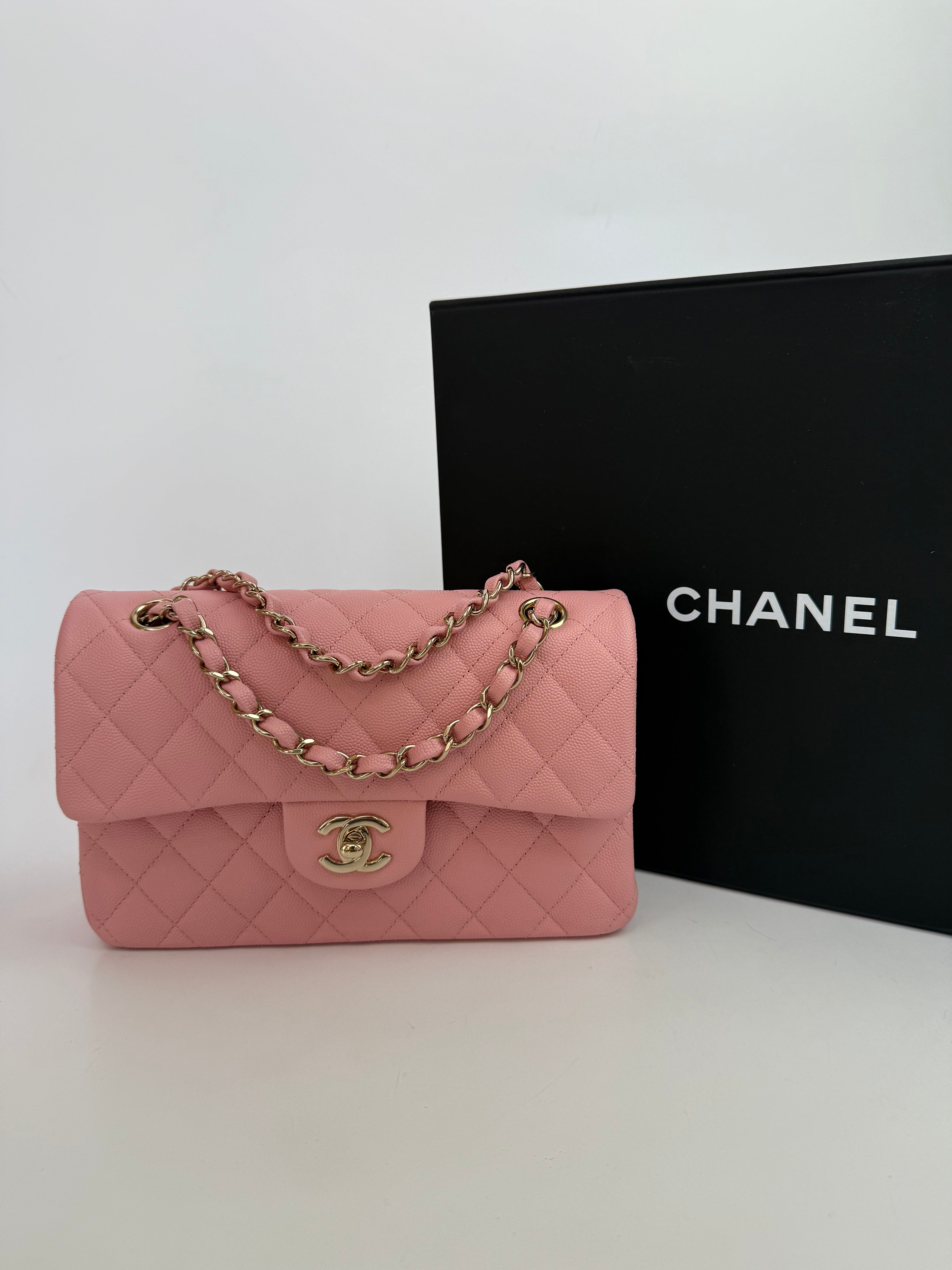 Authentic pre-loved Chanel Small Classic Double Flap In Pink Caviar Leather With Gold Hardware.