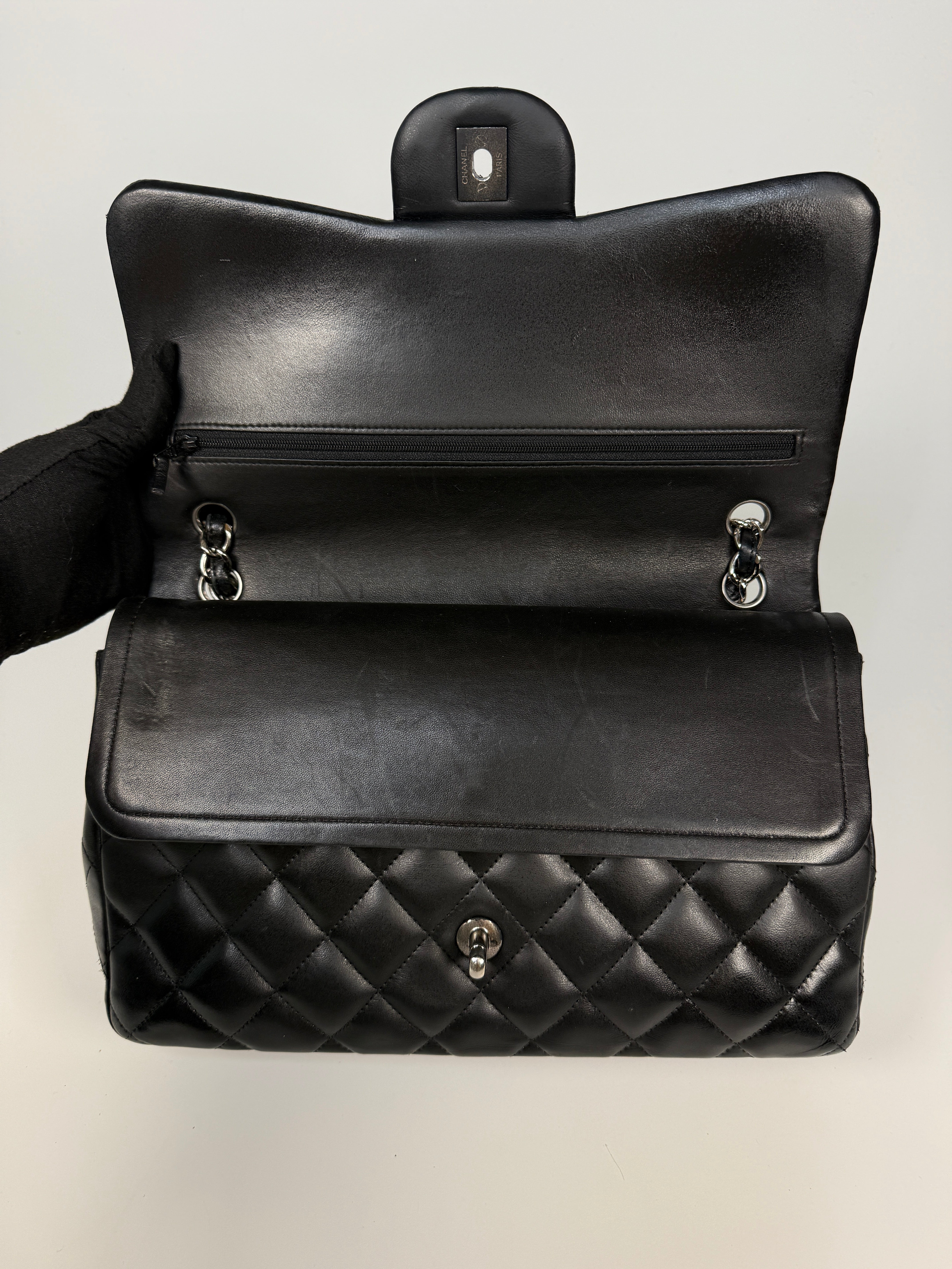 Authentic and preloved Chanel Jumbo Classic Flap Bag In Black Lambskin Leather With Silver hardware. Very Good condition. 100% Authenticity guarantee