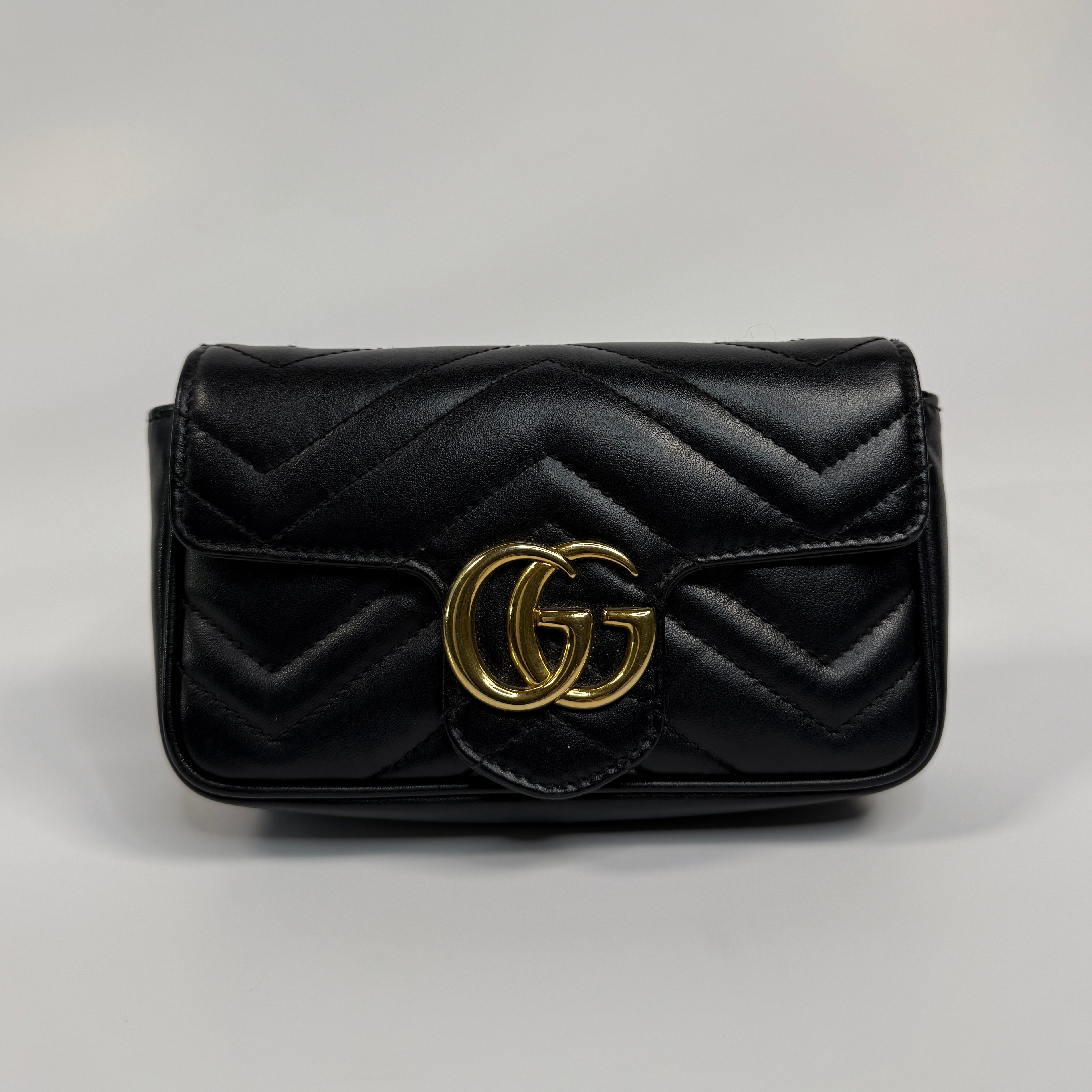 Authentic and preloved Gucci Marmont Matelassé Super Mini Bag In Black Leather With Gold Hardware in excellent condition