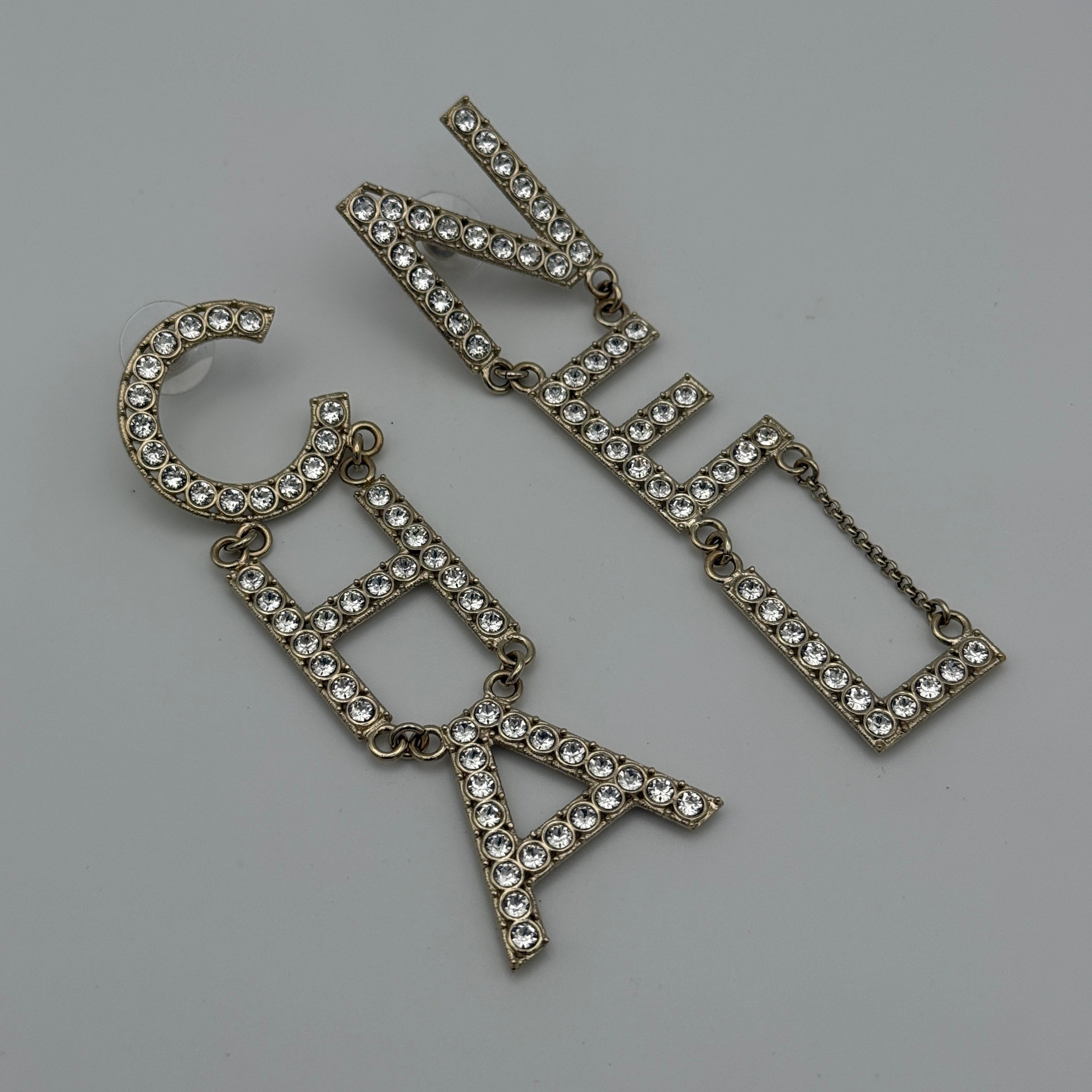 Authentic and preloved Chanel Crystal-Embellished Logo Earrings. 100% Authenticity Guarantee. Verified by Luxe Cheshire