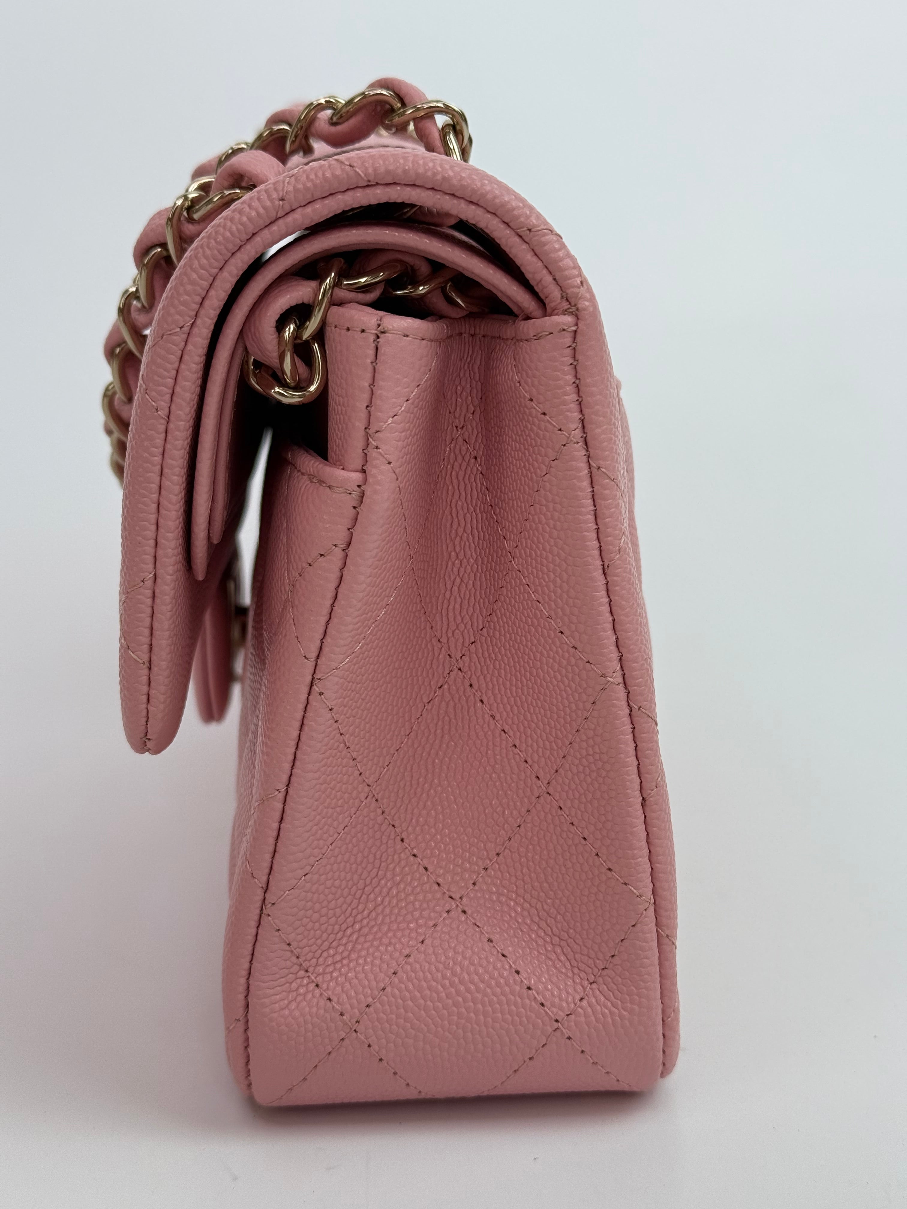 Authentic pre-loved Chanel Small Classic Double Flap In Pink Caviar Leather With Gold Hardware.