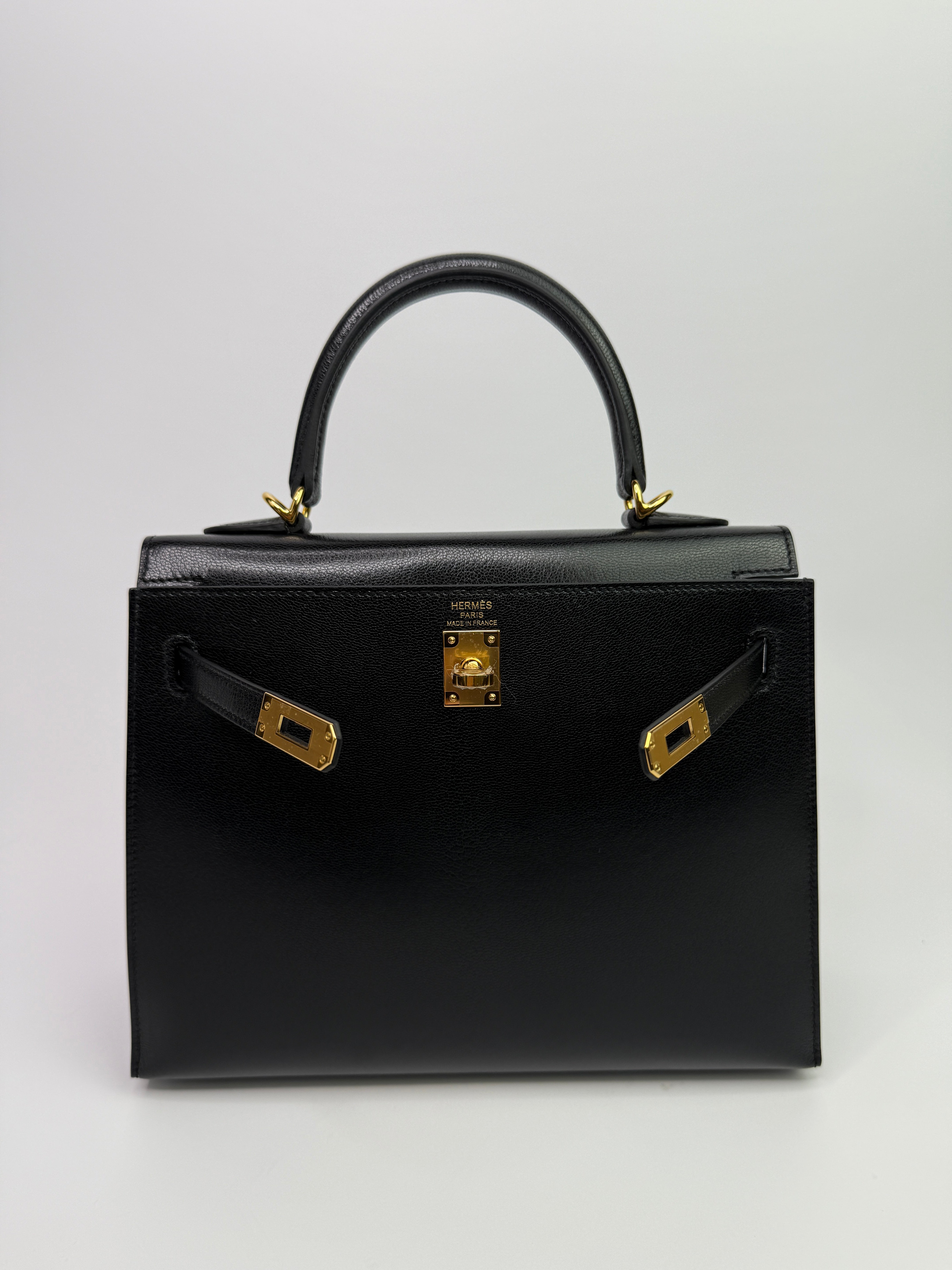 Authentic Pre Loved Hermès Kelly 25 Sellier In Black Chevre Chamilka Leather with Yellow Gold Hardware New & Unused Condition