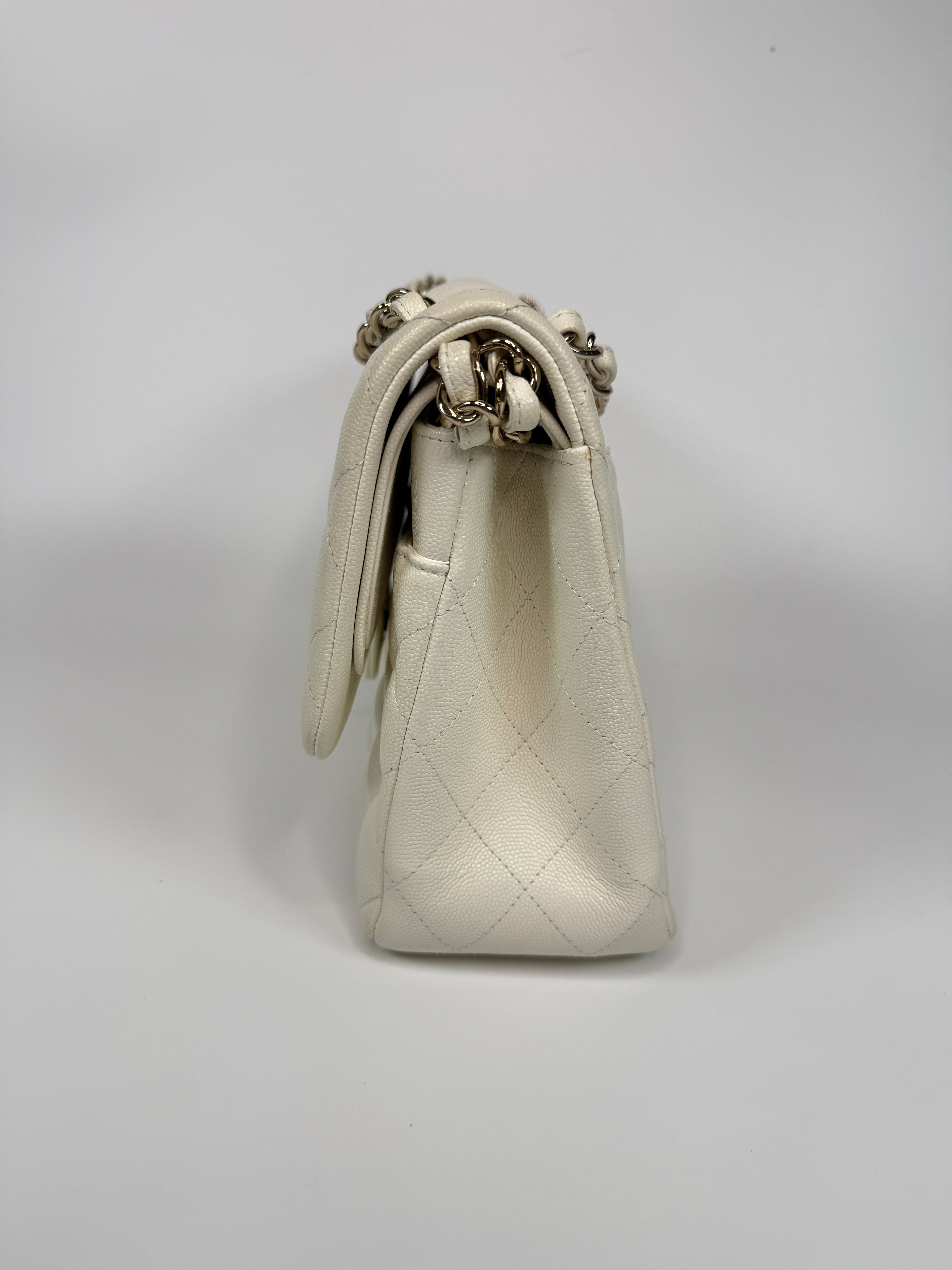 Authentic pre-loved Chanel Classic Jumbo Flap Bag In White Caviar Leather With pale gold hardware in very good condition. Verified by Luxe Cheshire. International, fast and fully insured delivery. Trusted designer resale.