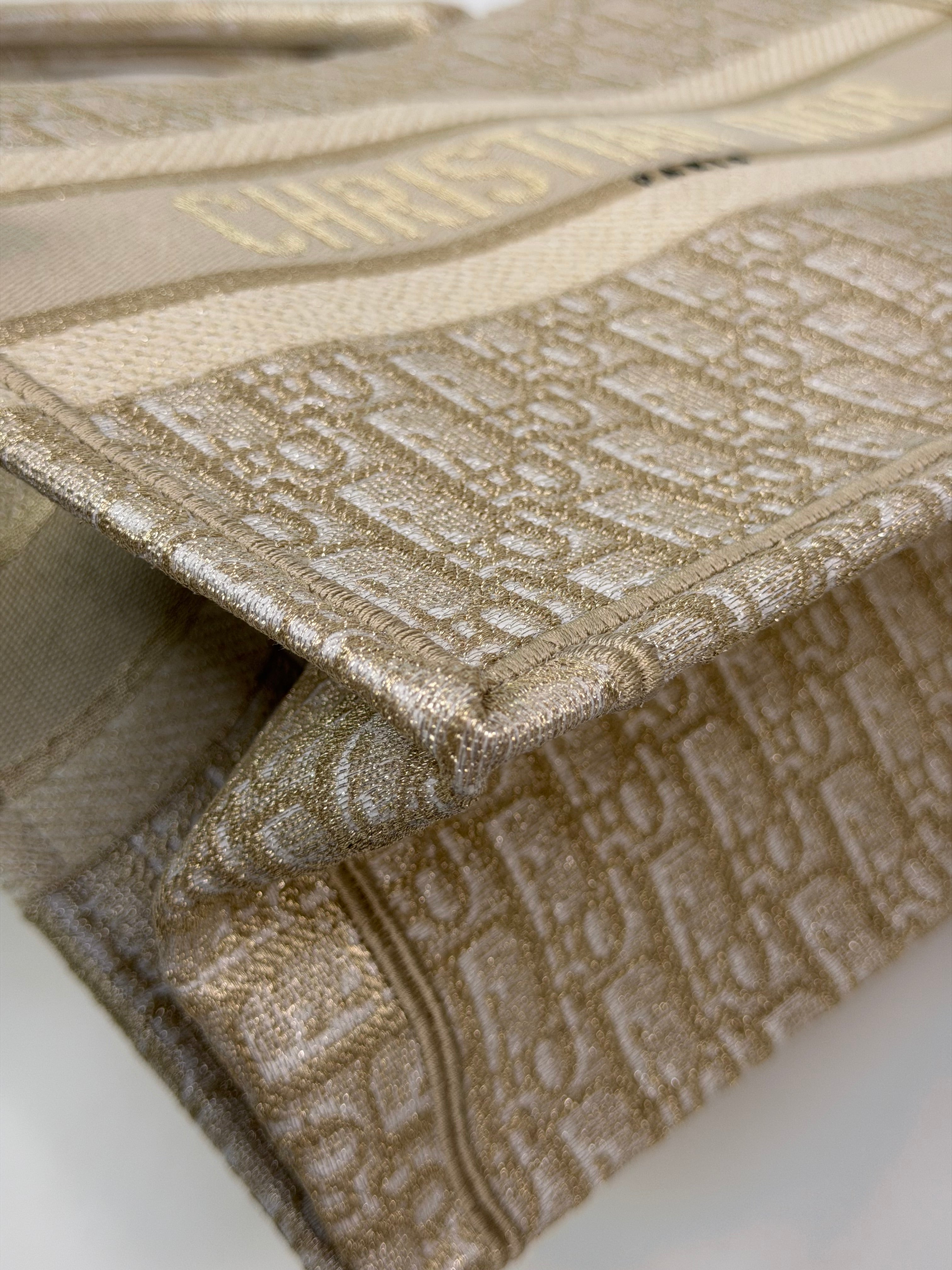 Christian Dior Medium Book Tote In Latte & Gold Tone Dioresque. Authentic and preloved in new and unused condition. 100% trusted guarantee