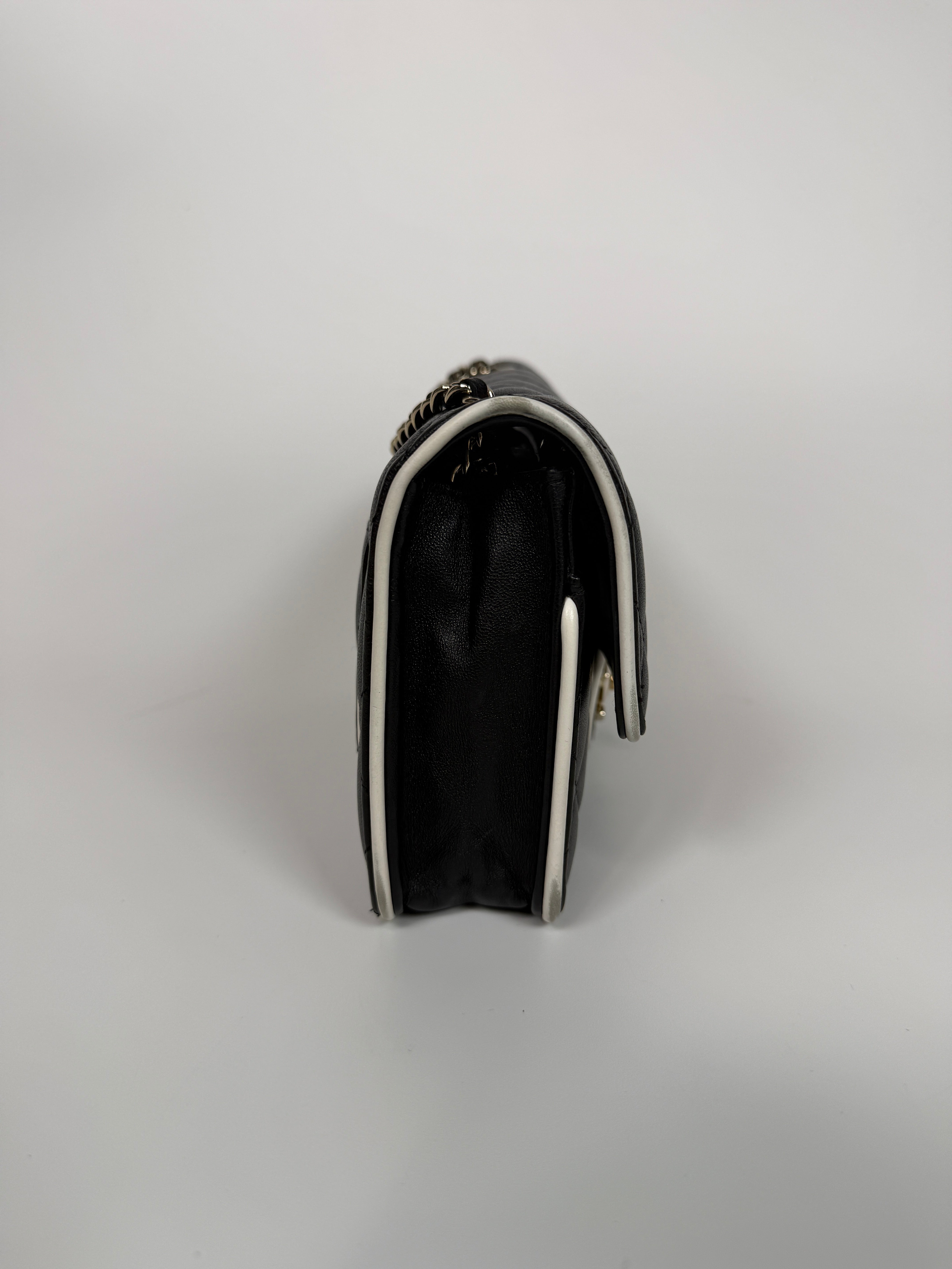 Authentic and preloved Chanel Wallet On Chain In Black & White Lambskin Leather With Pale Gold Hardware. Very Good Condition. 100% Authenticity Guarantee