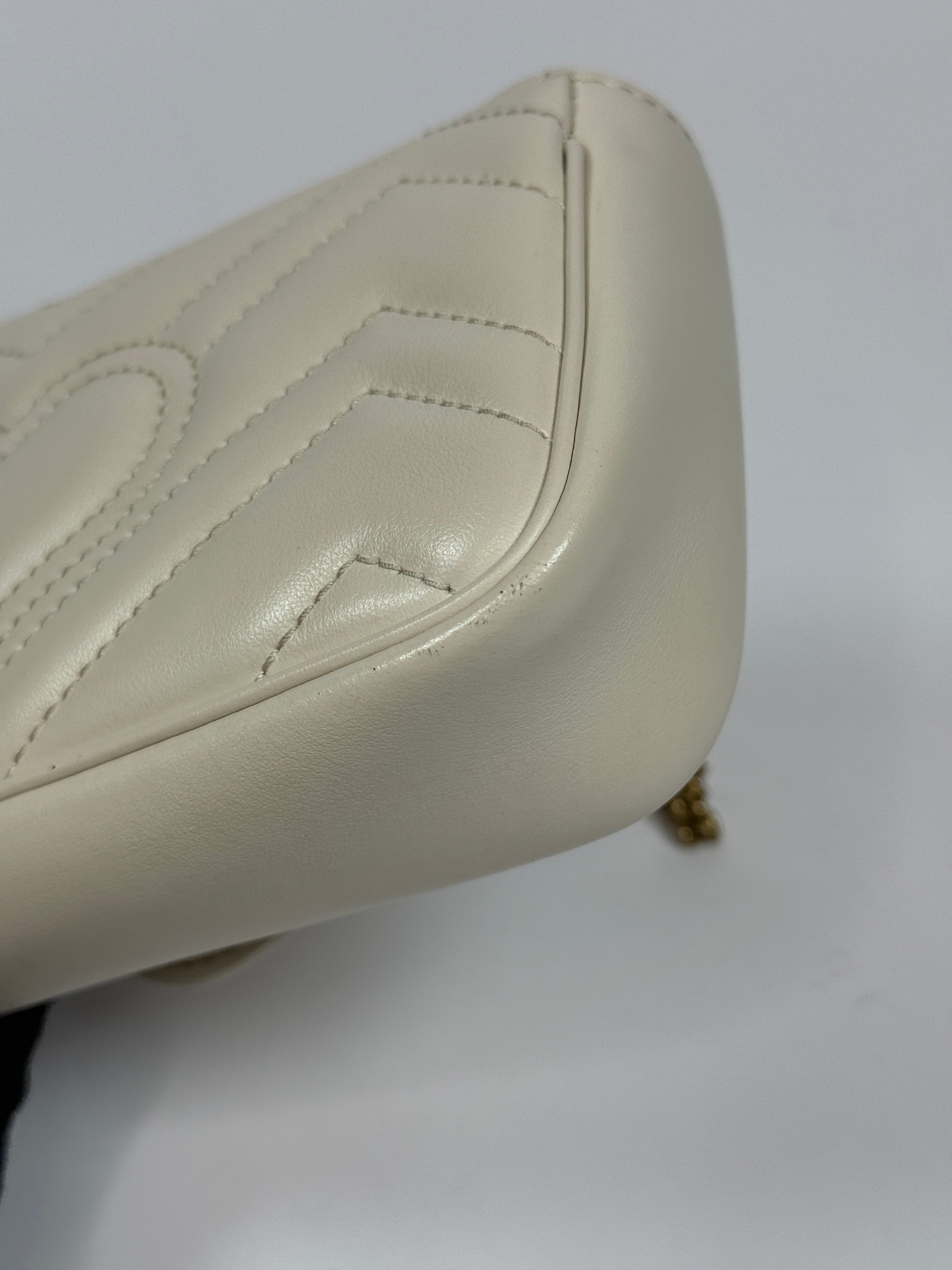 Gucci Marmont White Matelassé Super Mini Bag With Gold Hardware In Excellent pre loved condition. Authentic and preloved