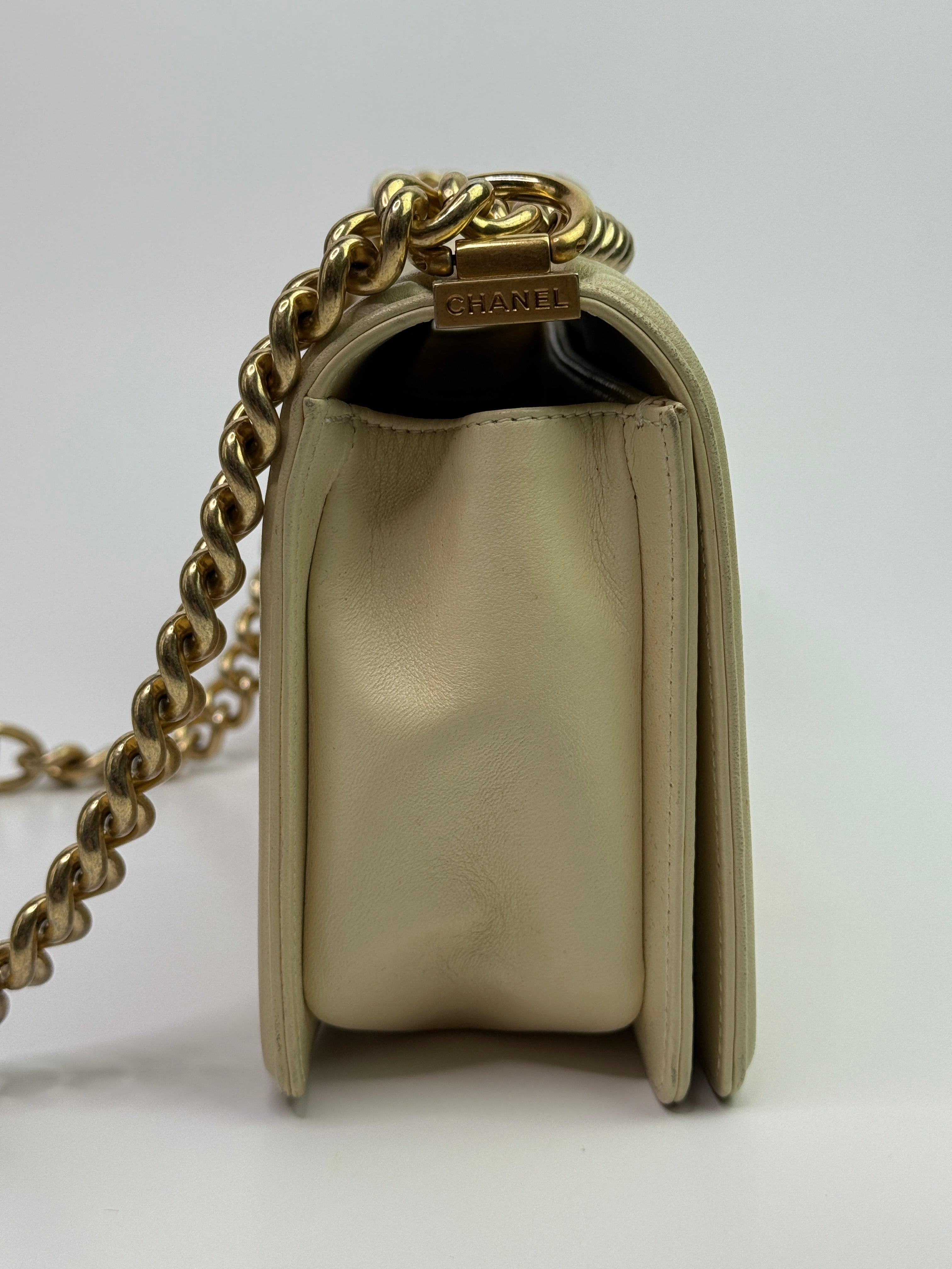 Authentic pre-loved Chanel Boy Bag Medium In Cream Lambskin With Gold Hardware.