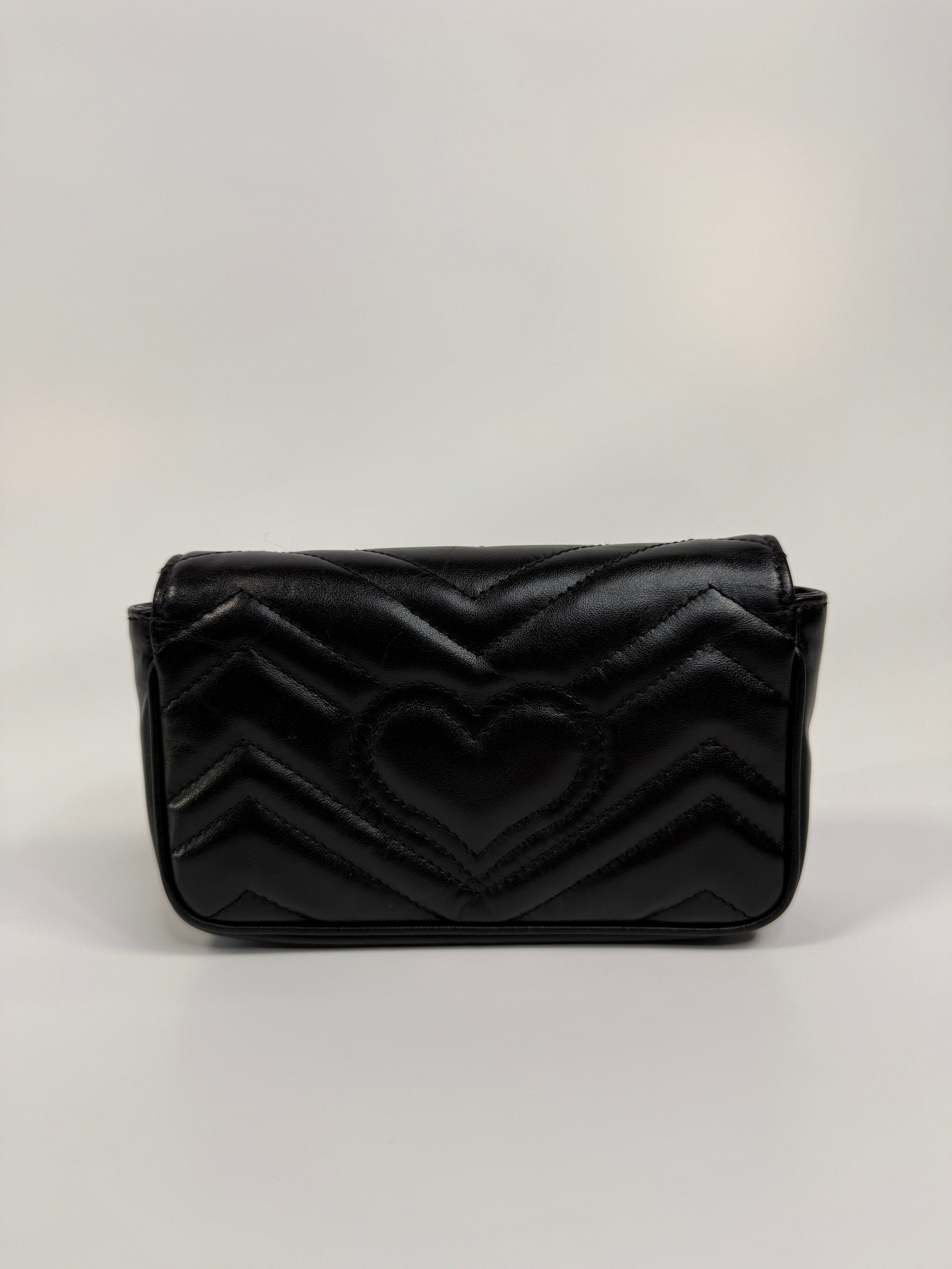 Authentic and preloved Gucci Marmont Matelassé Super Mini Bag In Black Leather With Gold Hardware in excellent condition