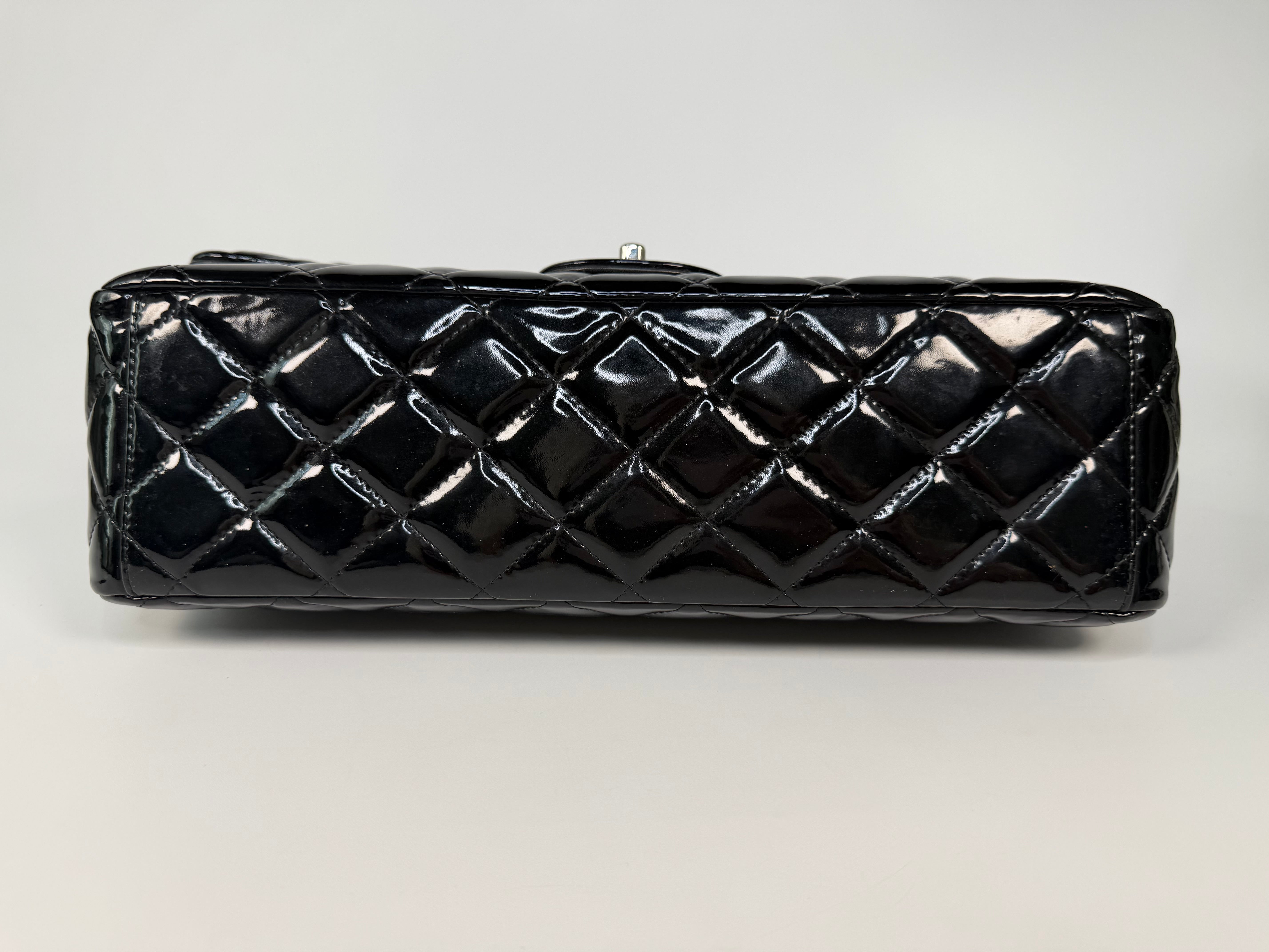 Chanel Maxi Classic Double Flap In Black Patent Leather With Silver Hardware. 100% authentic and preloved in excellent condition.