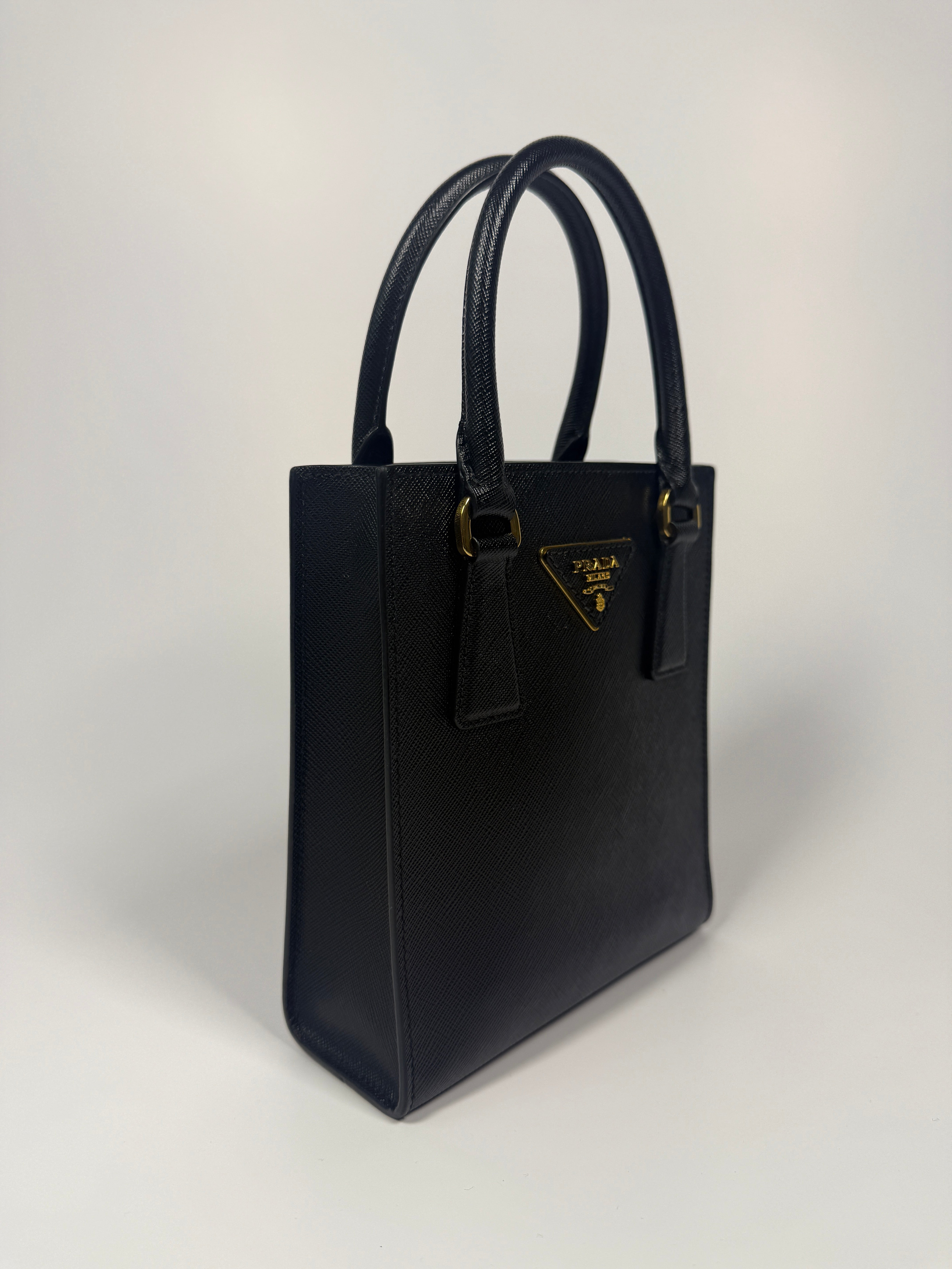 Prada Mini Tote In Black Saffiano Leather With Gold Hardware. 100% Authentic and preloved in excellent condition