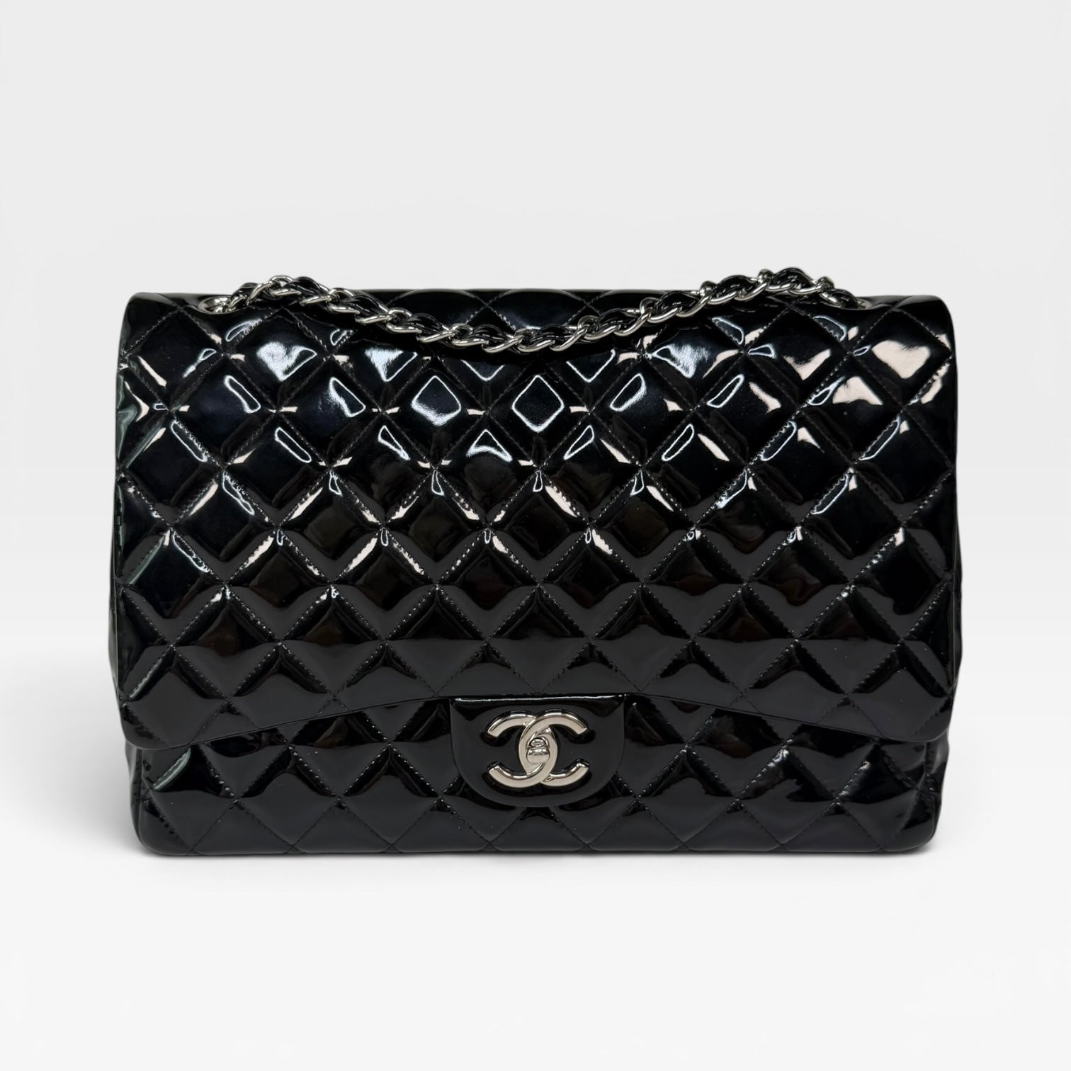Chanel Maxi Classic Double Flap In Black Patent Leather With Silver Hardware. 100% authentic and preloved in excellent condition.