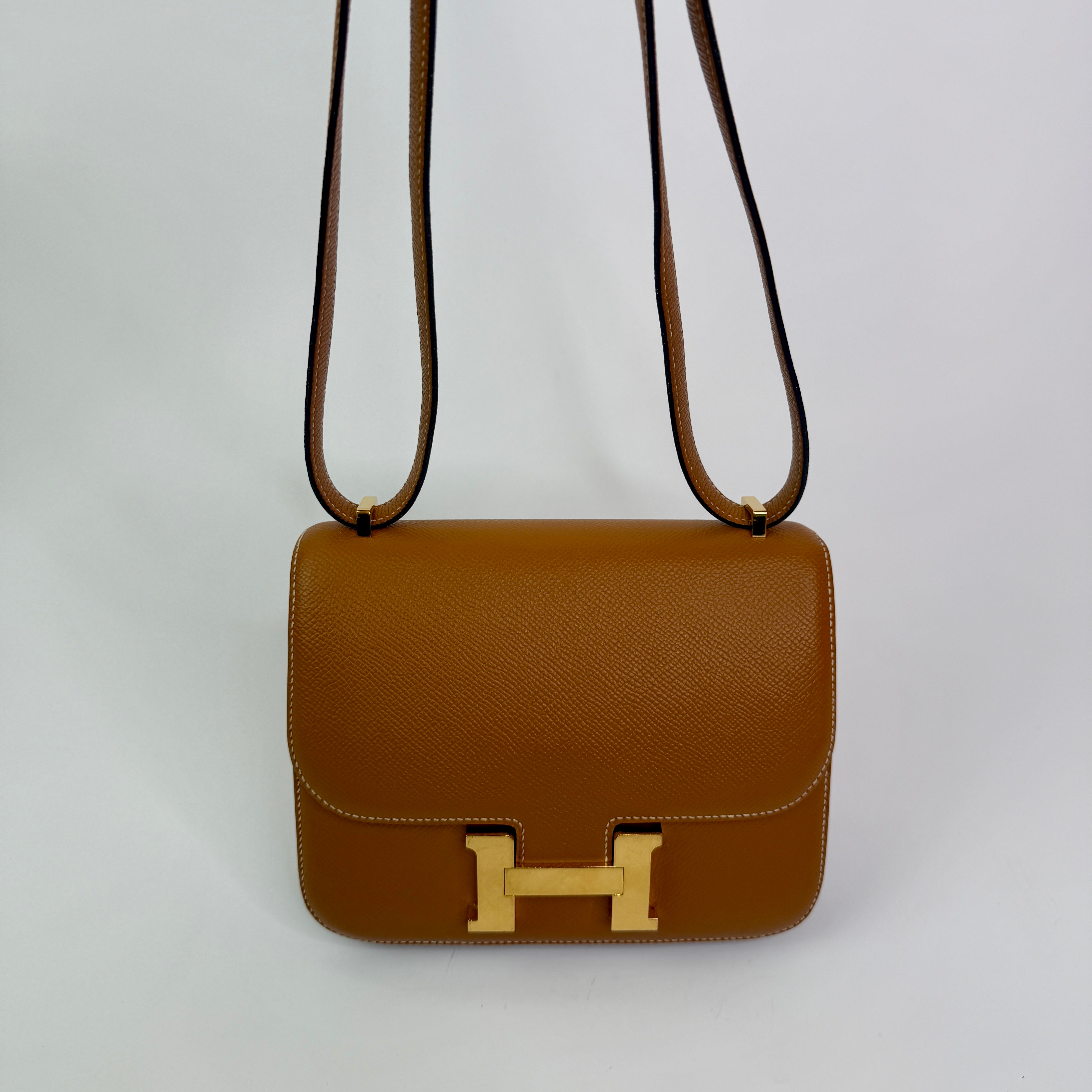 Authentic pre-lovedHermès Constance 18 In Toffee Epsom Leather With Gold Hardware.