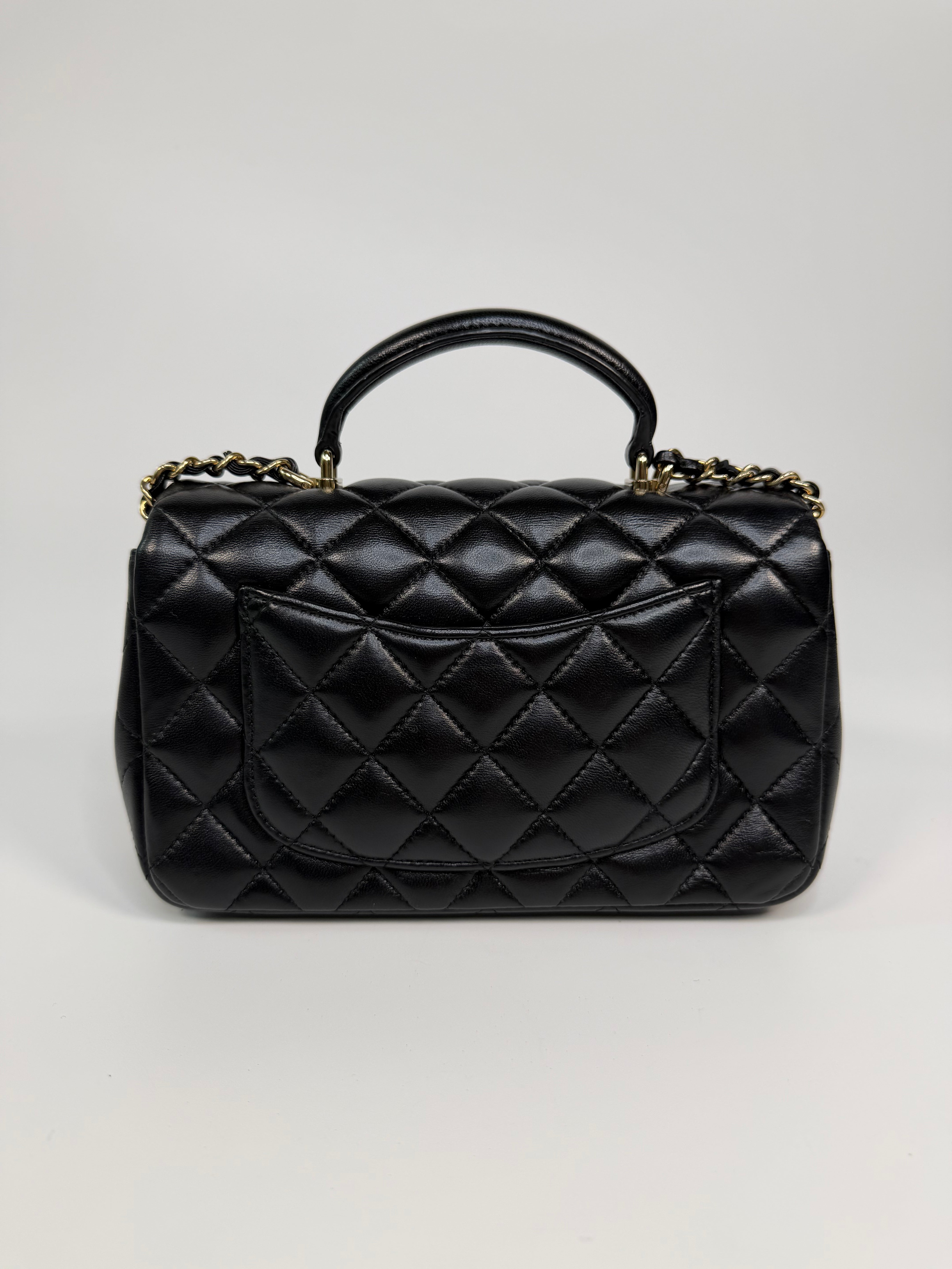 Chanel Mini Rectangle Top Handle In Black Lambskin Leather With Pale Gold Hardware. Authentic and preloved in excellent condition.