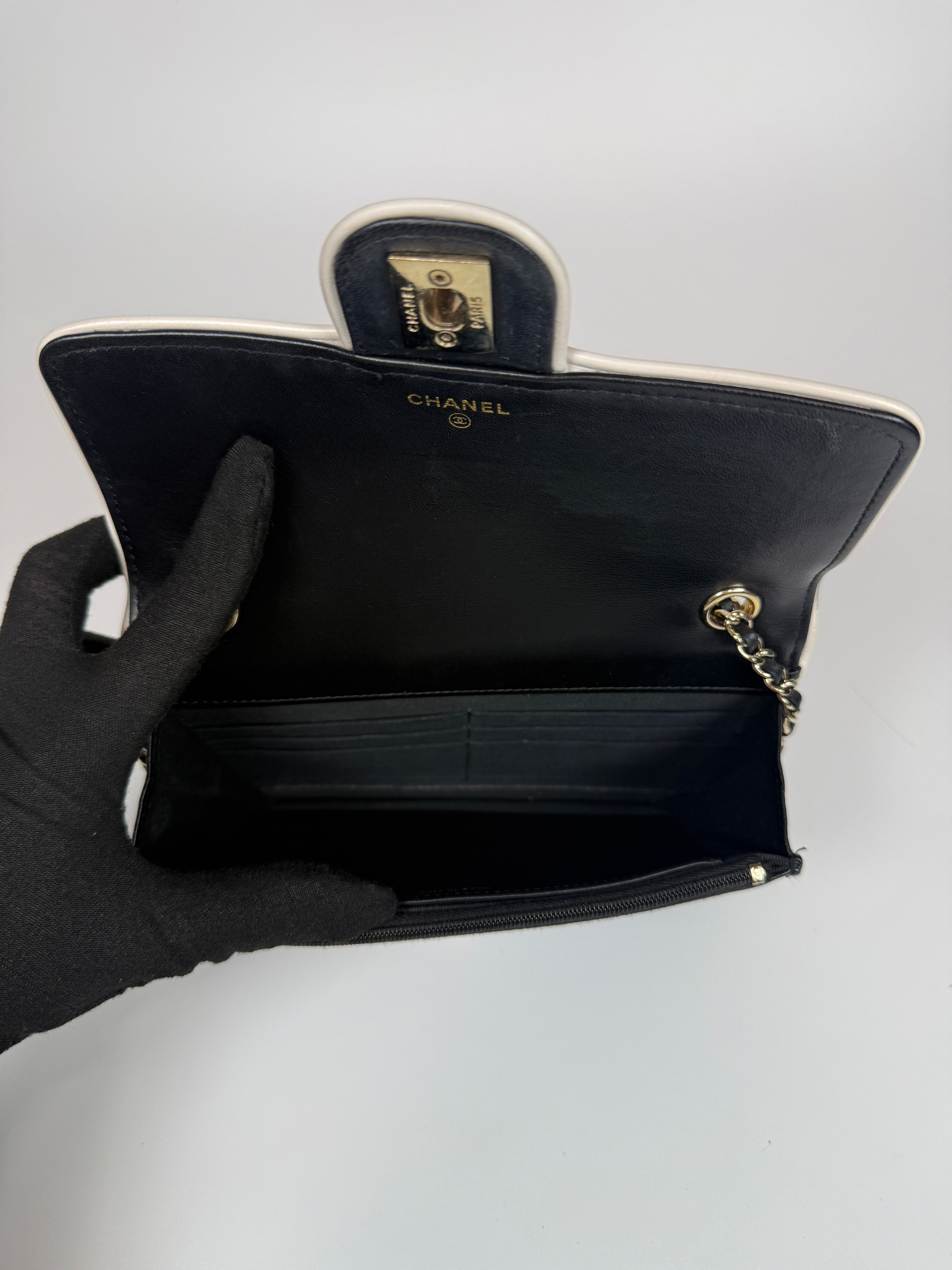 Authentic and preloved Chanel Wallet On Chain In Black & White Lambskin Leather With Pale Gold Hardware. Very Good Condition. 100% Authenticity Guarantee