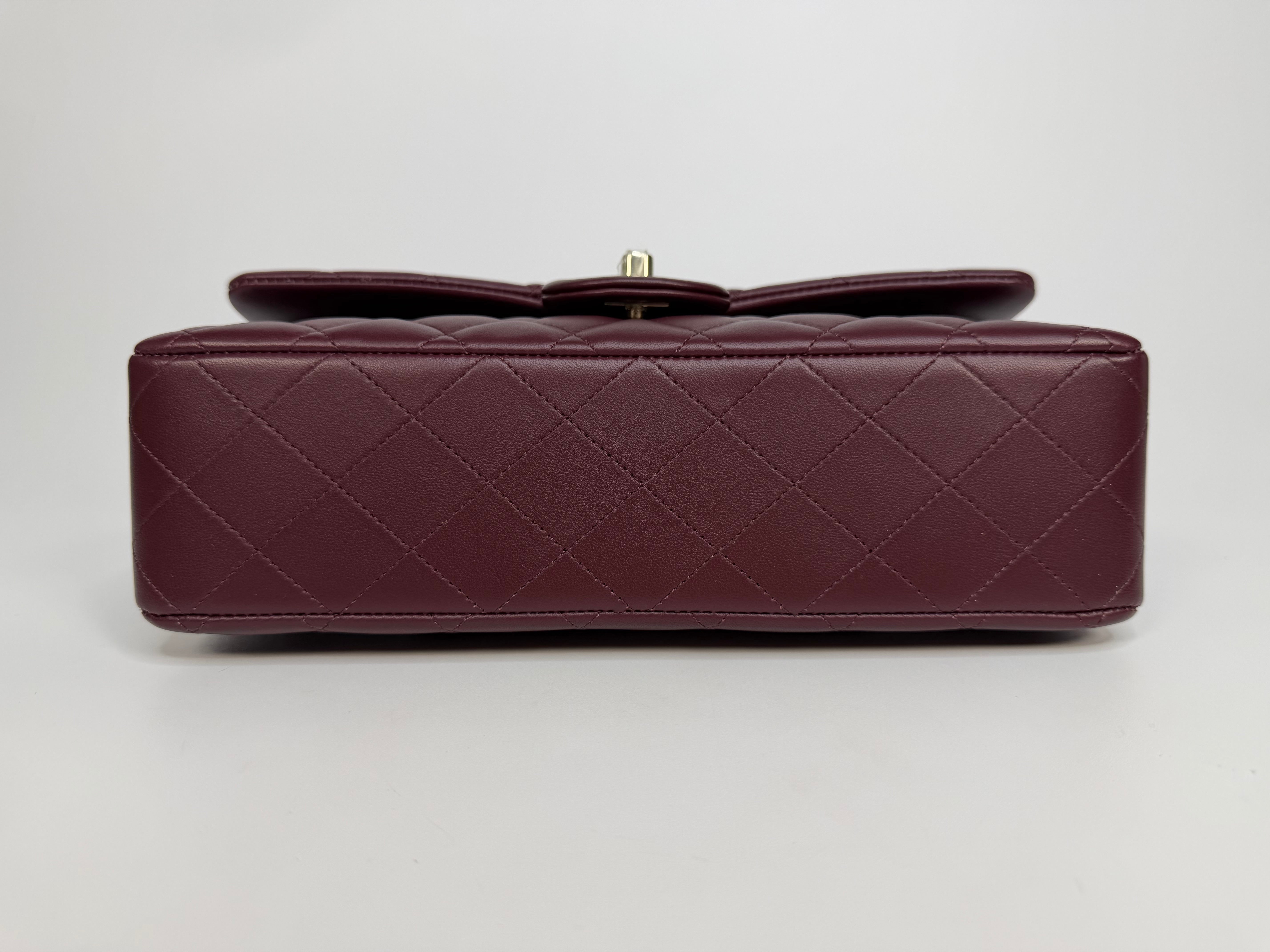 Chanel Medium Classic Double Flap Burgundy Lambskin Leather With Pale Gold Hardware. Authentic and preloved in excellent condition with 100% authenticity guarantee.