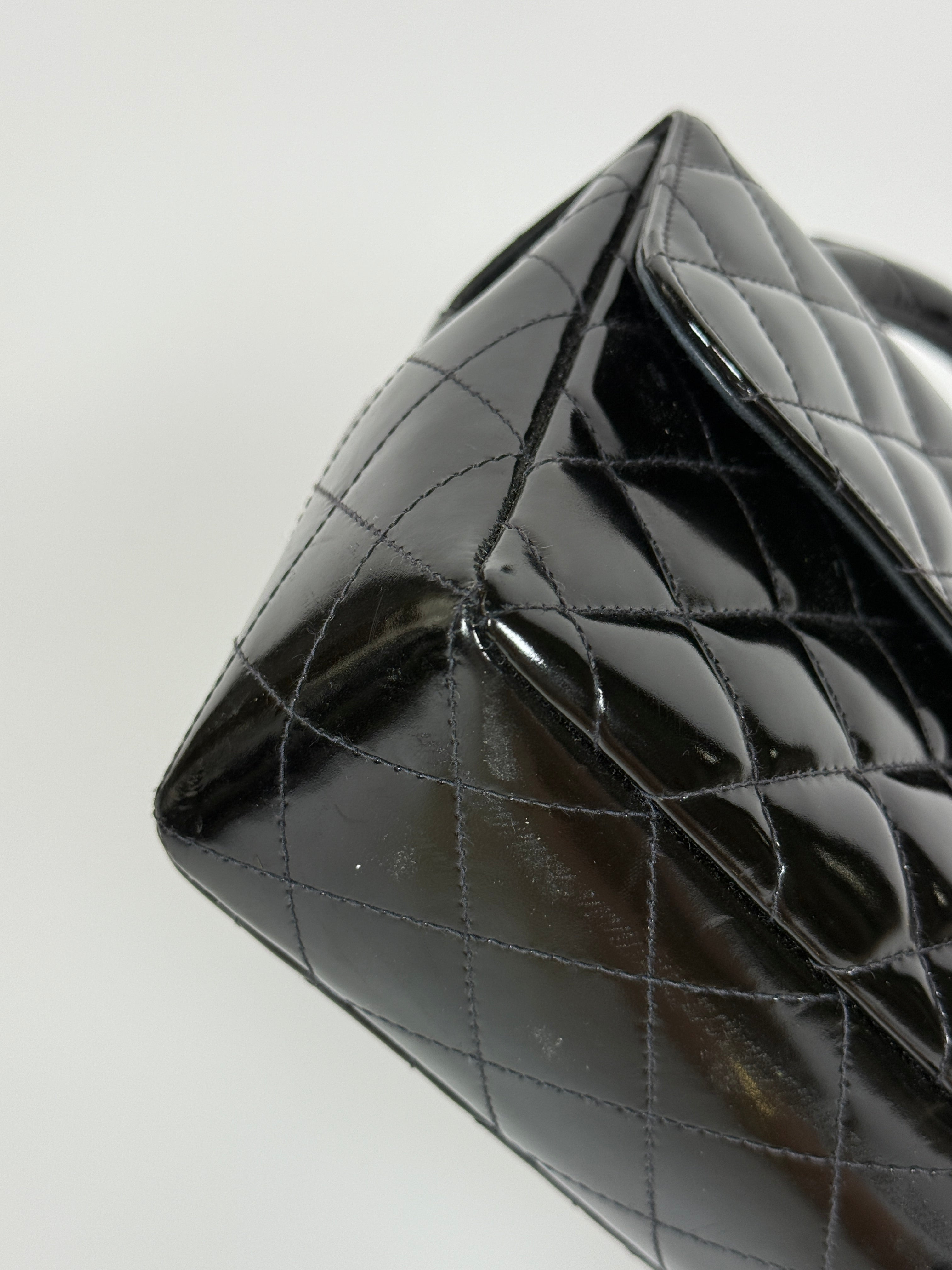 Authentic and preloved Chanel Vintage Kelly Top Handle Bag In Black Patent Leather With 24kt Gold Hardware. Very Good condition. 100% Authenticity guarantee