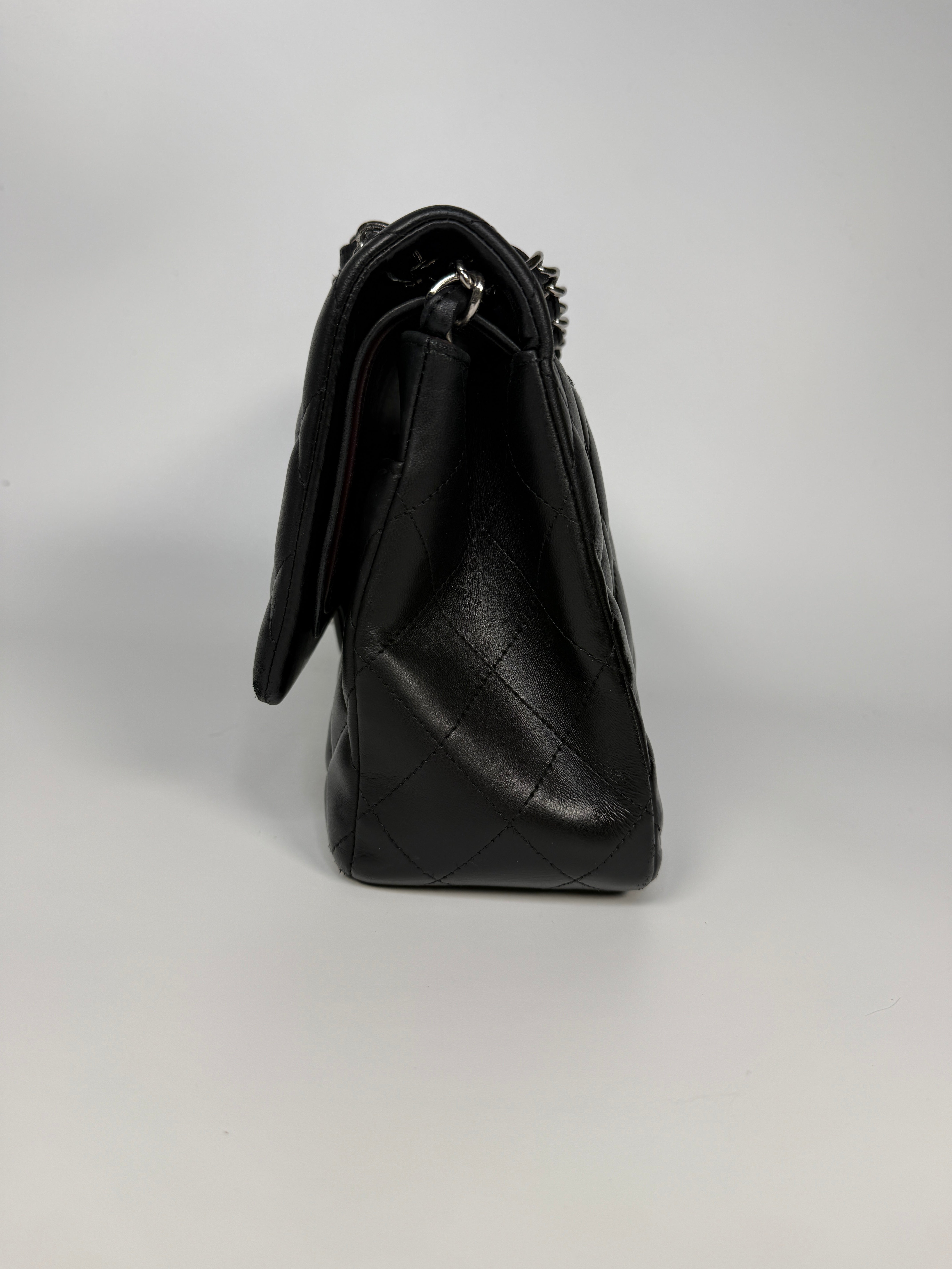 Authentic and preloved Chanel Jumbo Classic Flap Bag In Black Lambskin Leather With Silver hardware. Very Good condition. 100% Authenticity guarantee