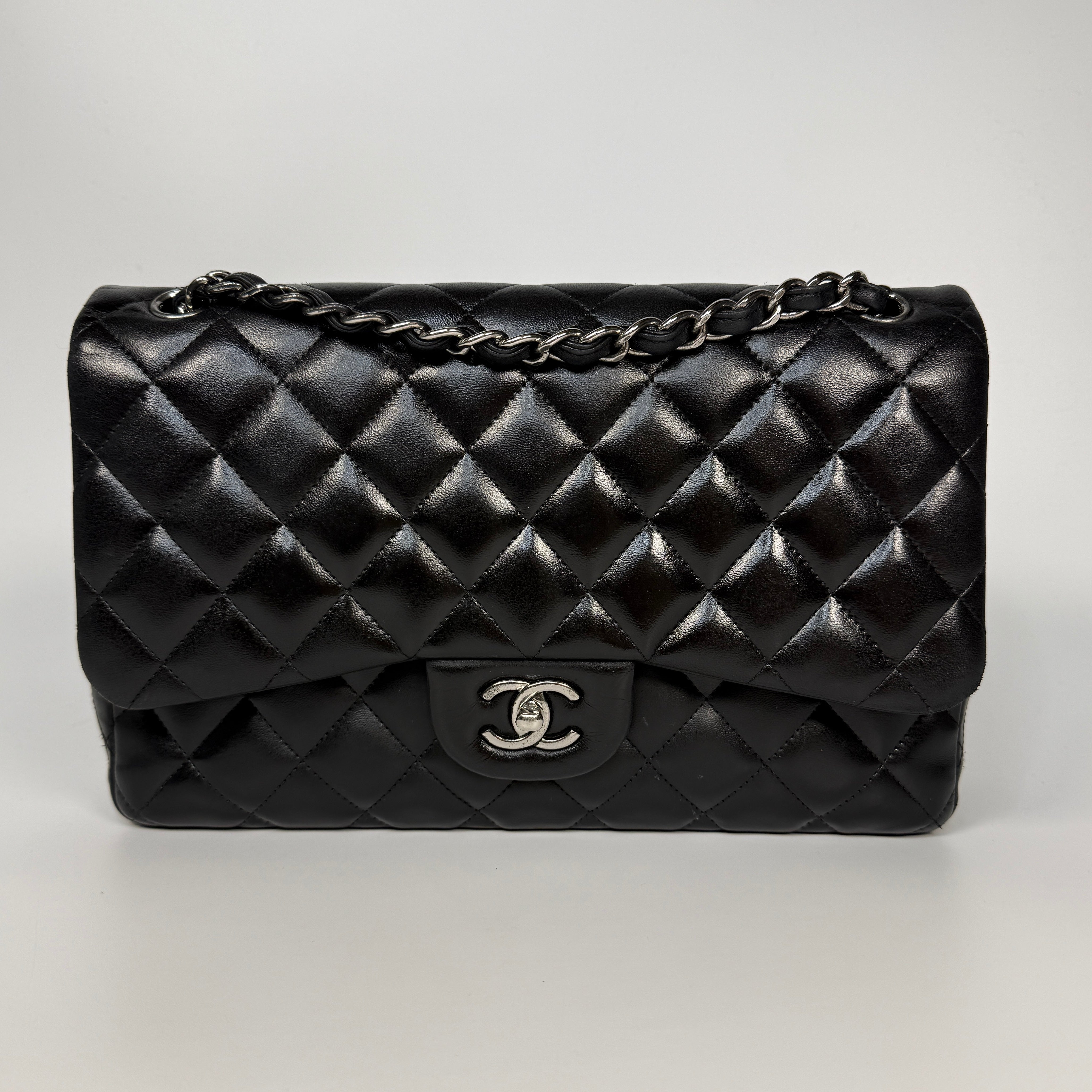 Authentic and preloved Chanel Jumbo Classic Flap Bag In Black Lambskin Leather With Silver hardware. Very Good condition. 100% Authenticity guarantee