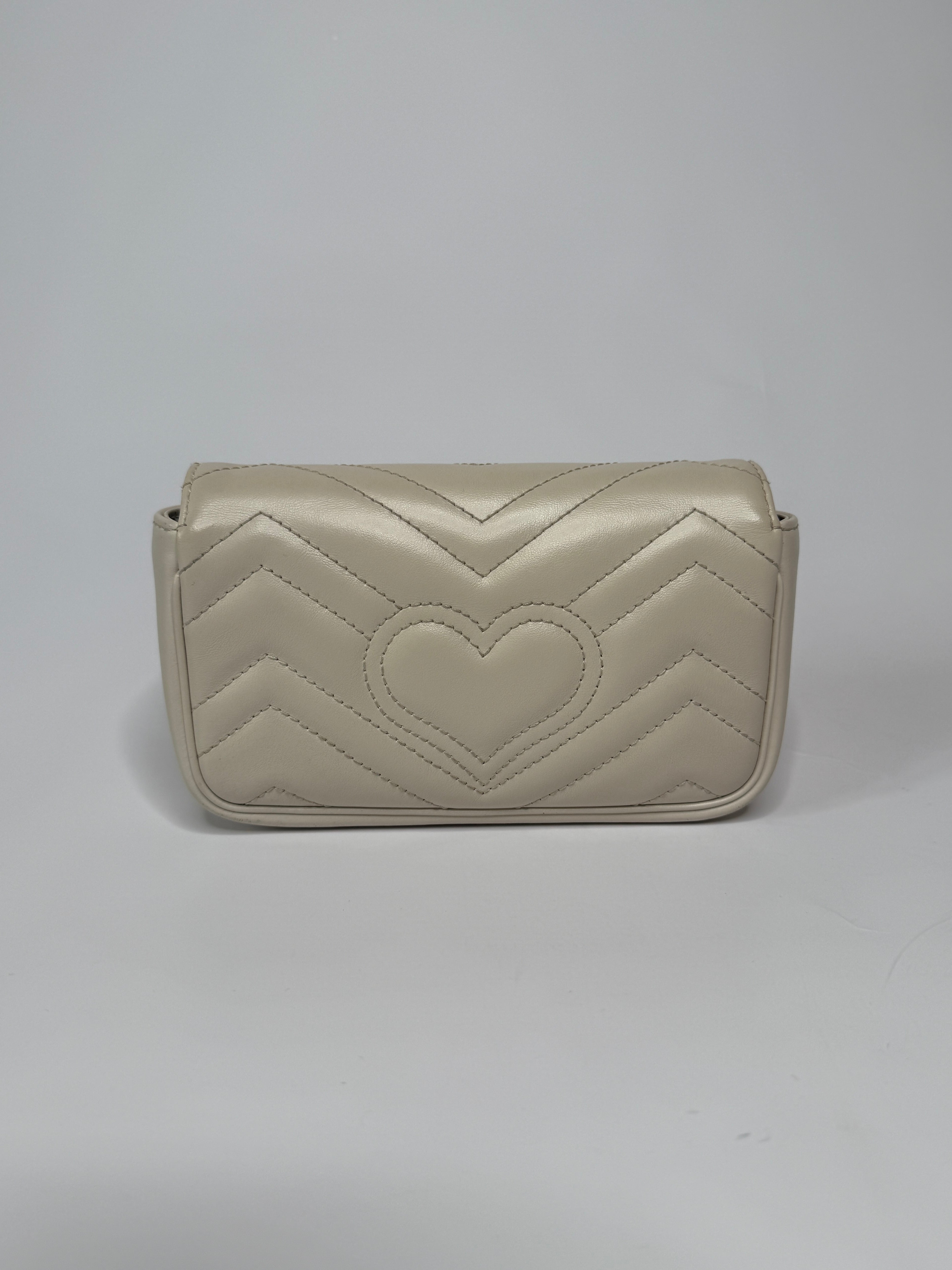 Gucci Marmont White Matelassé Super Mini Bag With Gold Hardware In Excellent pre loved condition. Authentic and preloved