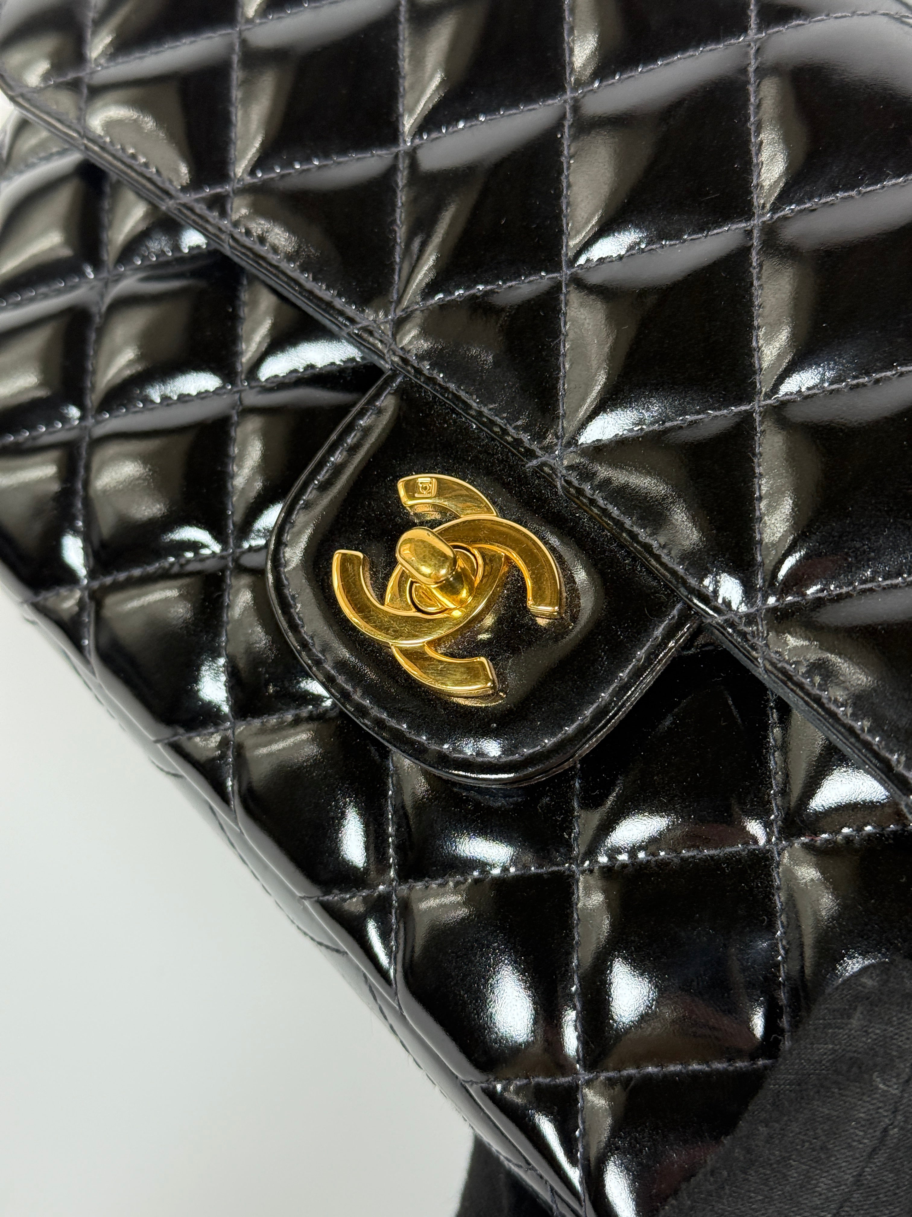 Authentic and preloved Chanel Vintage Kelly Top Handle Bag In Black Patent Leather With 24kt Gold Hardware. Very Good condition. 100% Authenticity guarantee