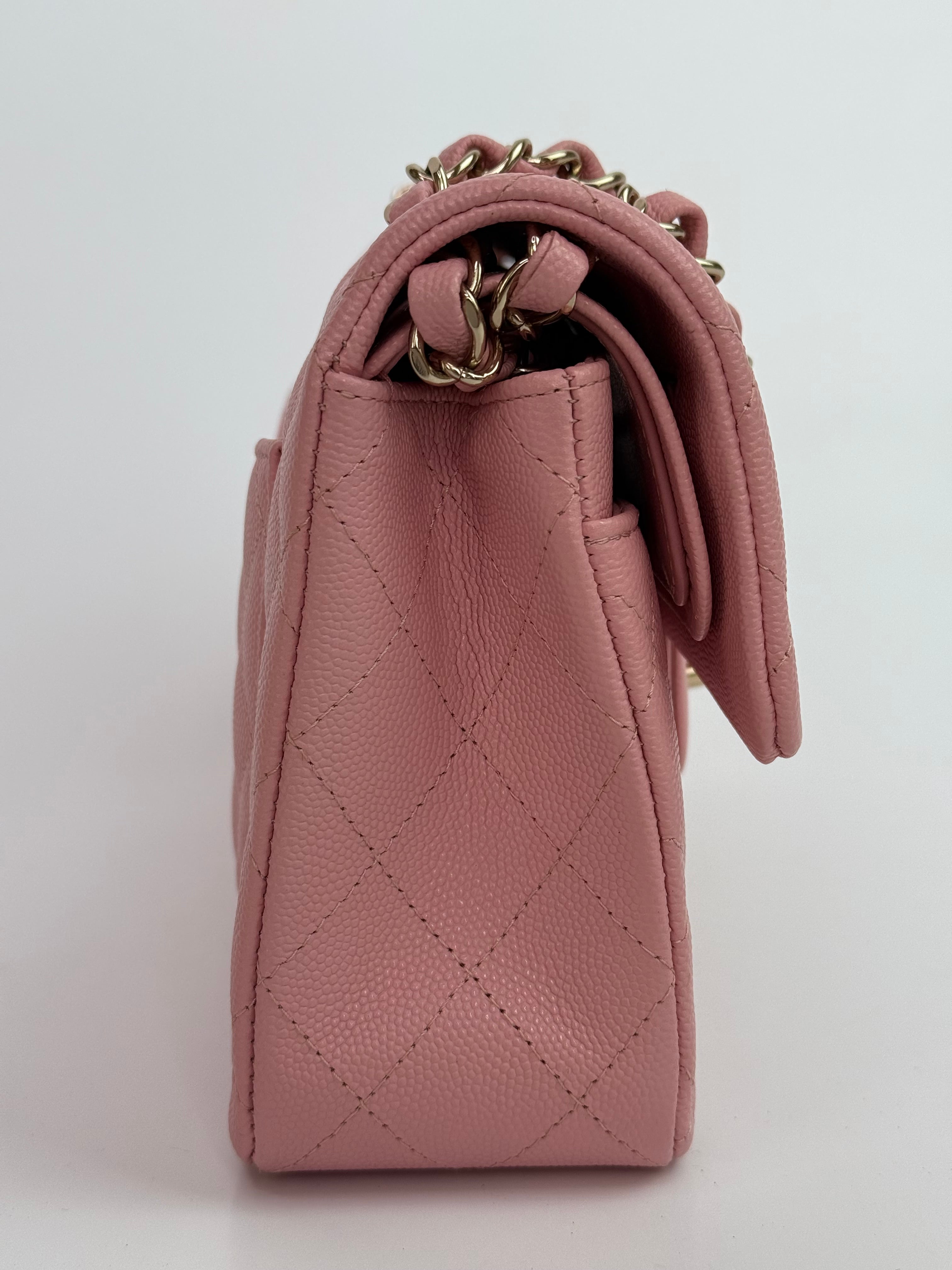 Authentic pre-loved Chanel Small Classic Double Flap In Pink Caviar Leather With Gold Hardware.