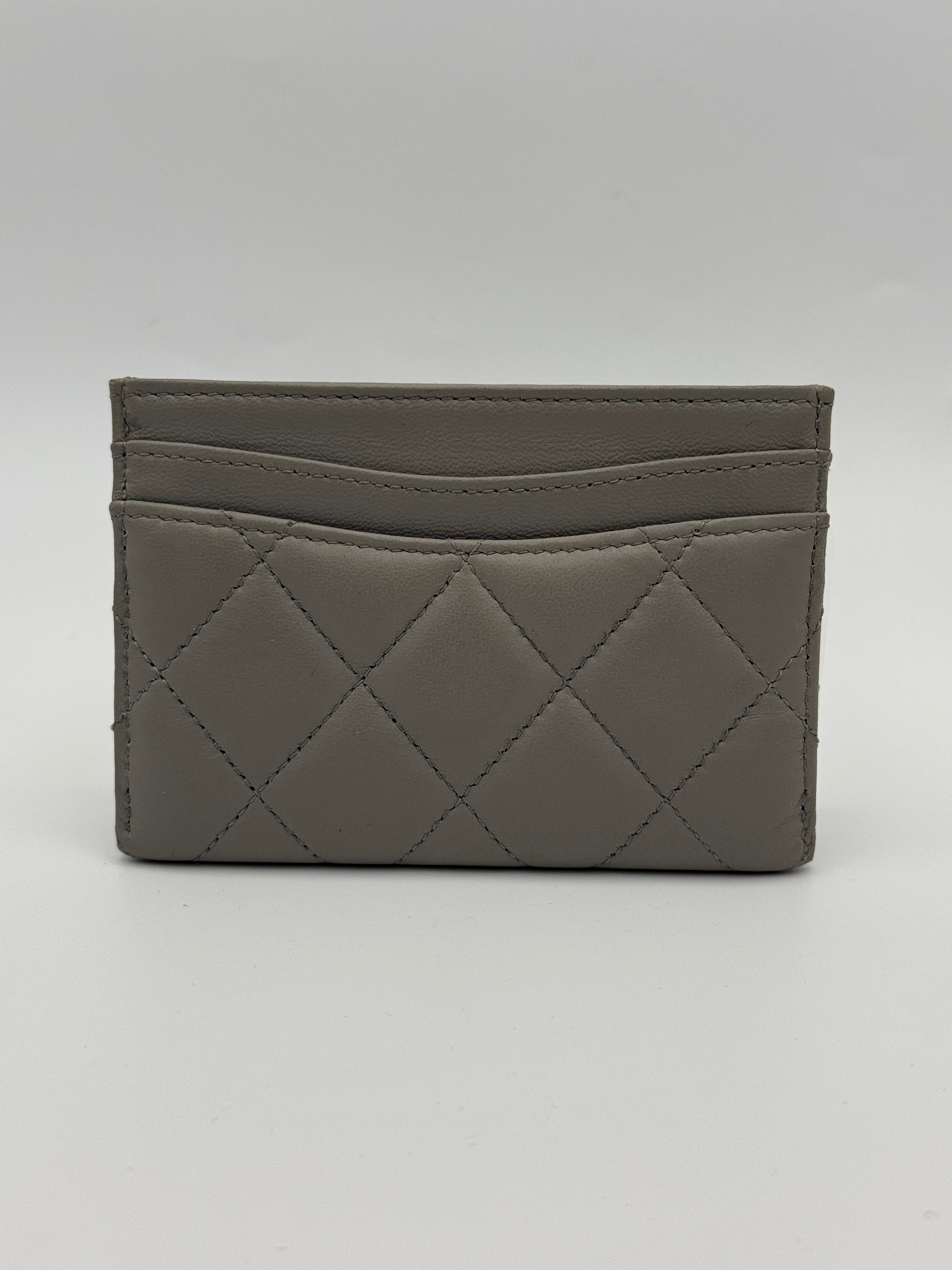 Authentic and pre loved Chanel Classic Card Holder In Grey Lambskin Leather With Silver hardware. Excellent Condition. 100% Authenticity guarantee.