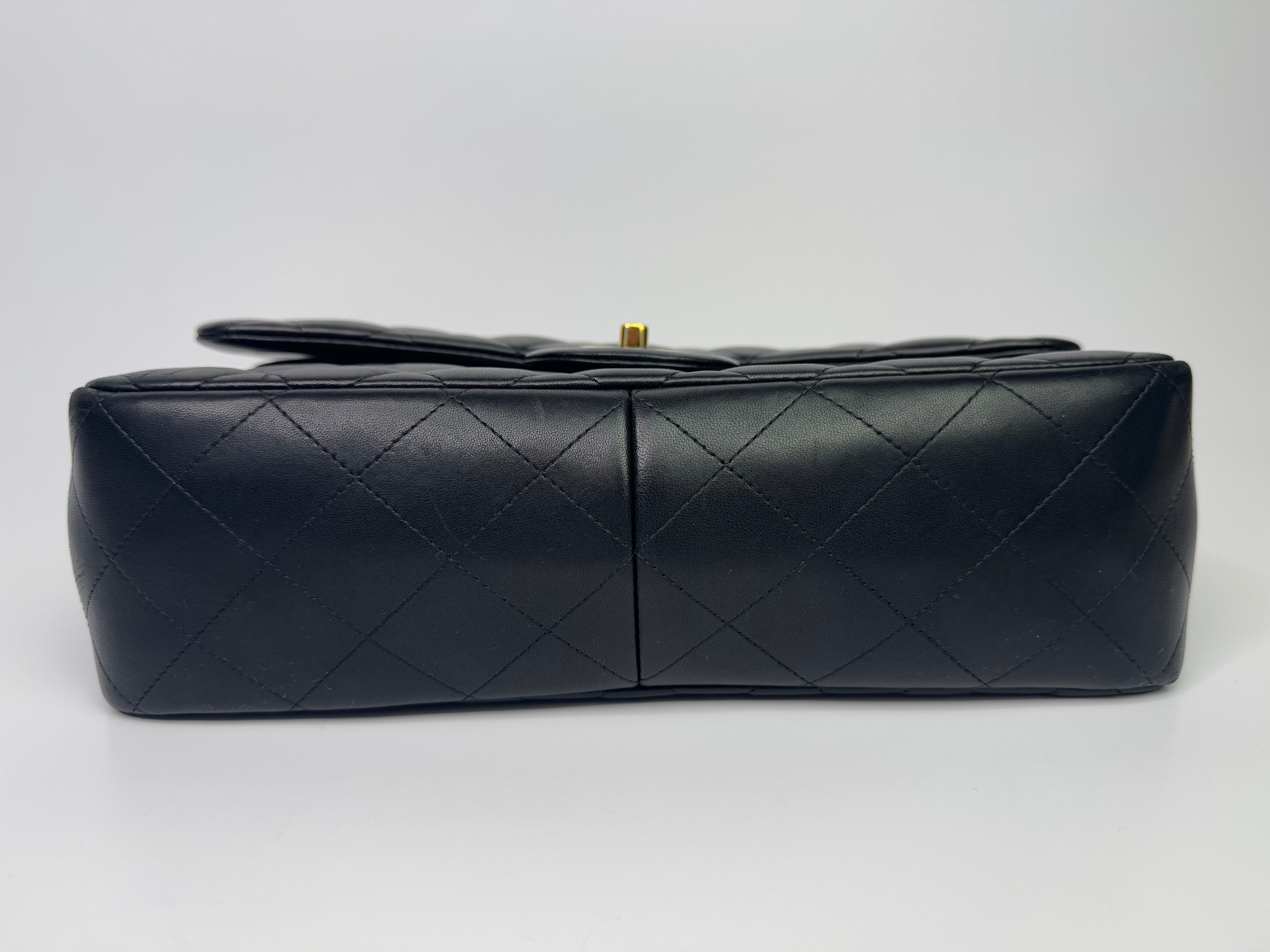 Authentic pre-loved Chanel Black Lambskin Leather Jumbo Classic Double Flap With Gold Hardware.