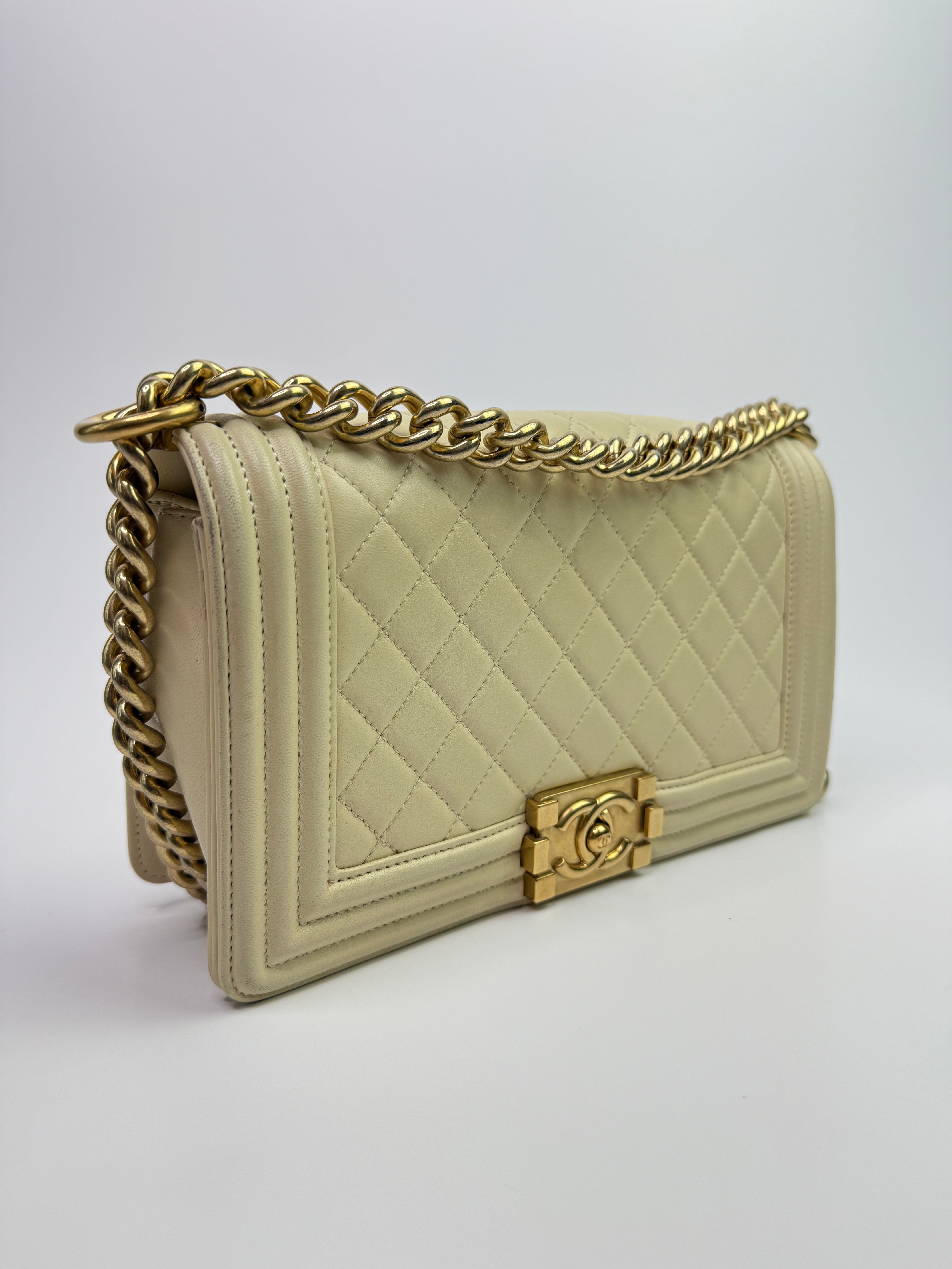 Authentic pre-loved Chanel Boy Bag Medium In Cream Lambskin With Gold Hardware.
