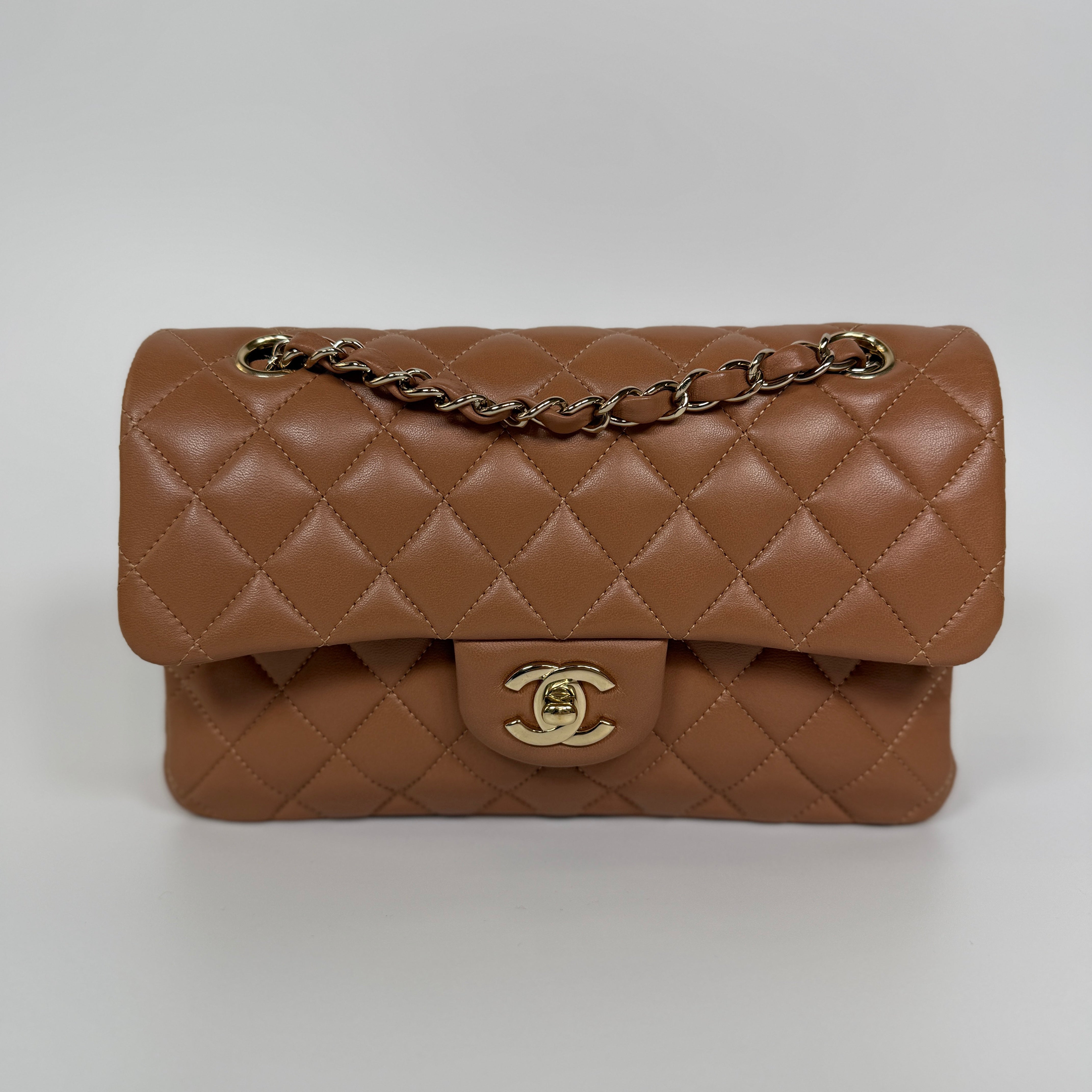 Authentic and pre loved Chanel Small Classic Double Flap In Brown Lambskin Leather With Gold hardware. Excellent condition. 100% Authenticity guarantee.