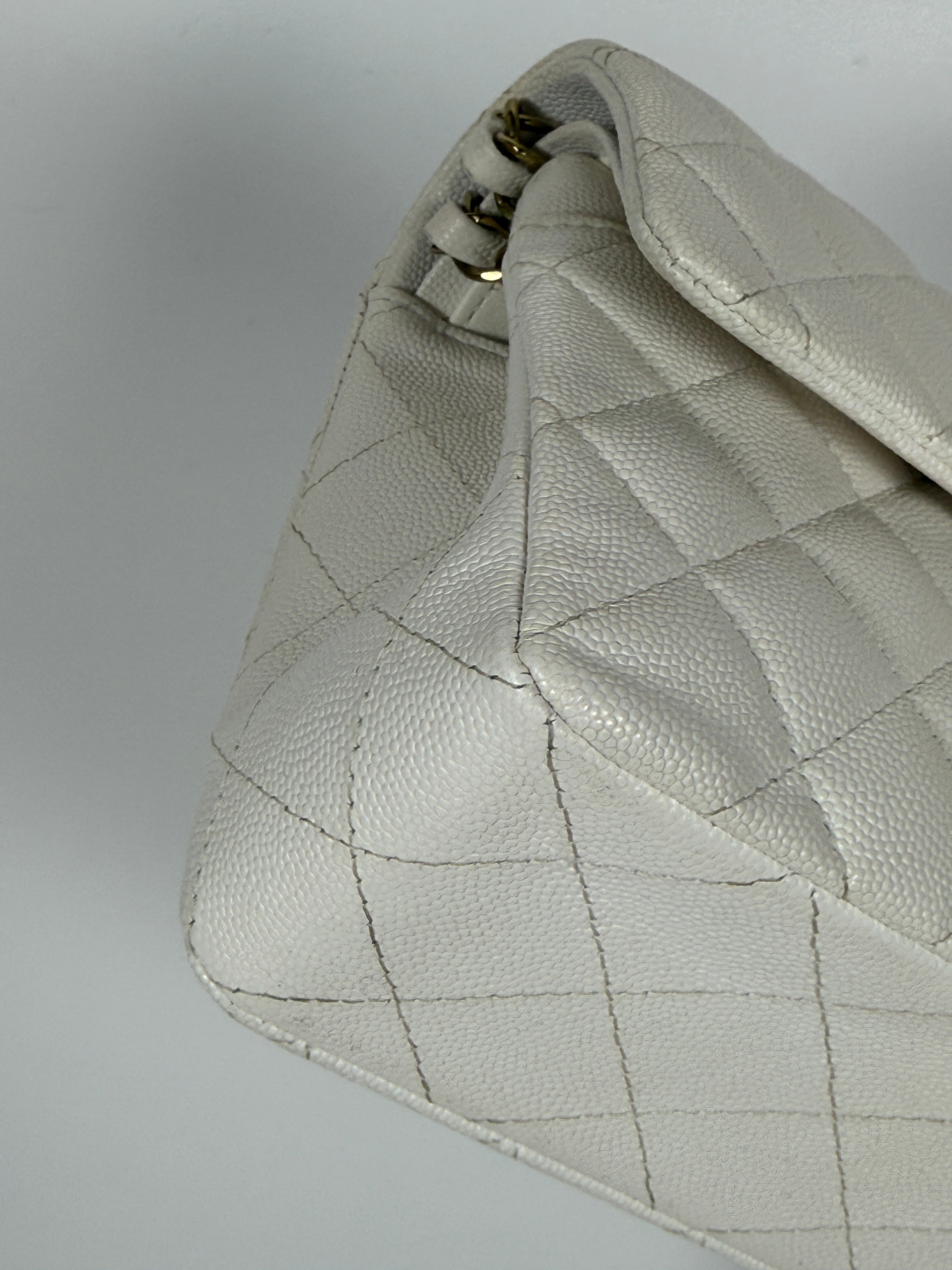 Authentic and preloved Chanel Small Classic Double Flap In White Caviar Leather With pale gold hardware. Very Good Condition. 100% Authenticity guarantee