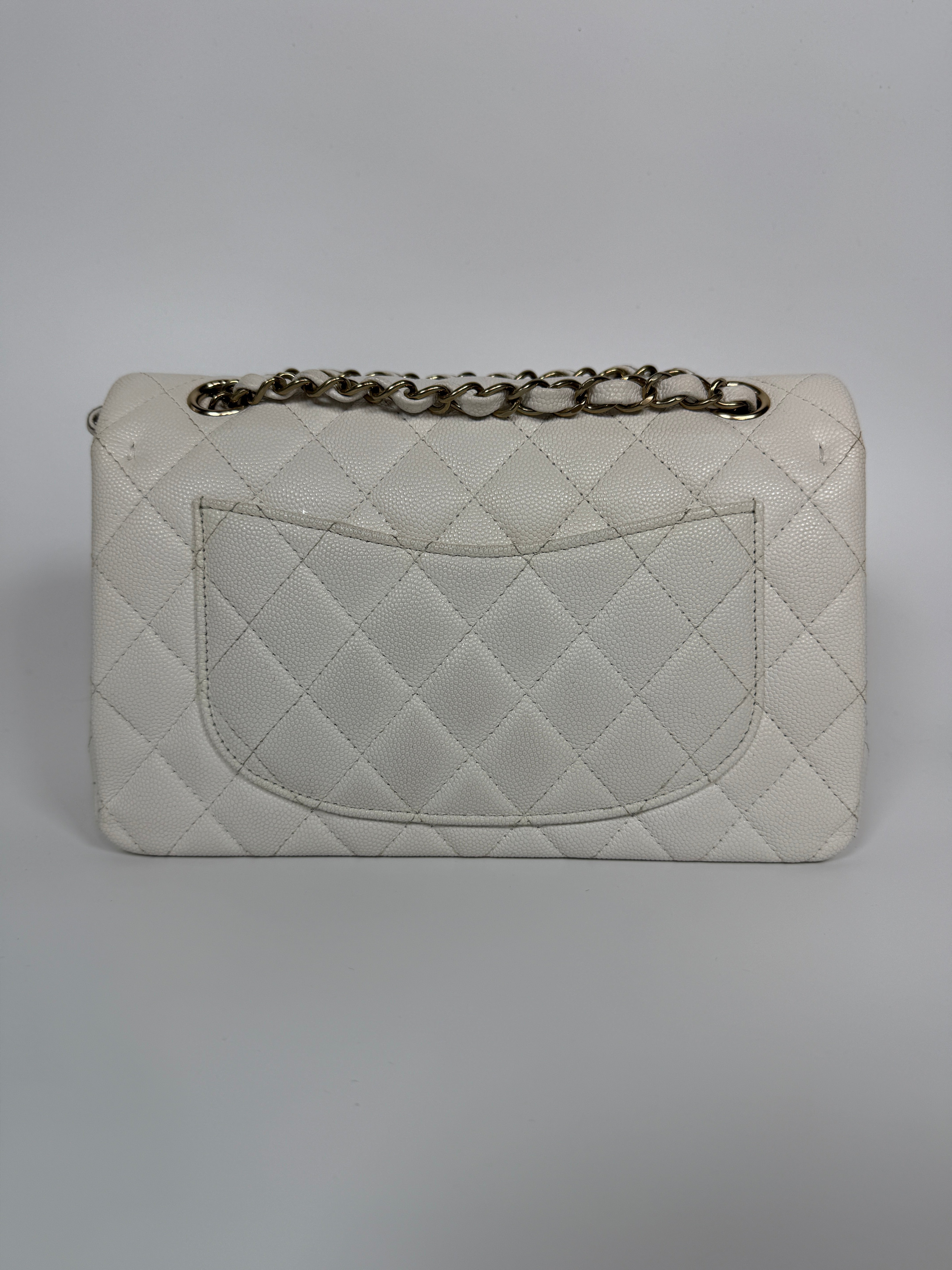 Authentic and preloved Chanel Small Classic Double Flap In White Caviar Leather With pale gold hardware. Very Good Condition. 100% Authenticity guarantee