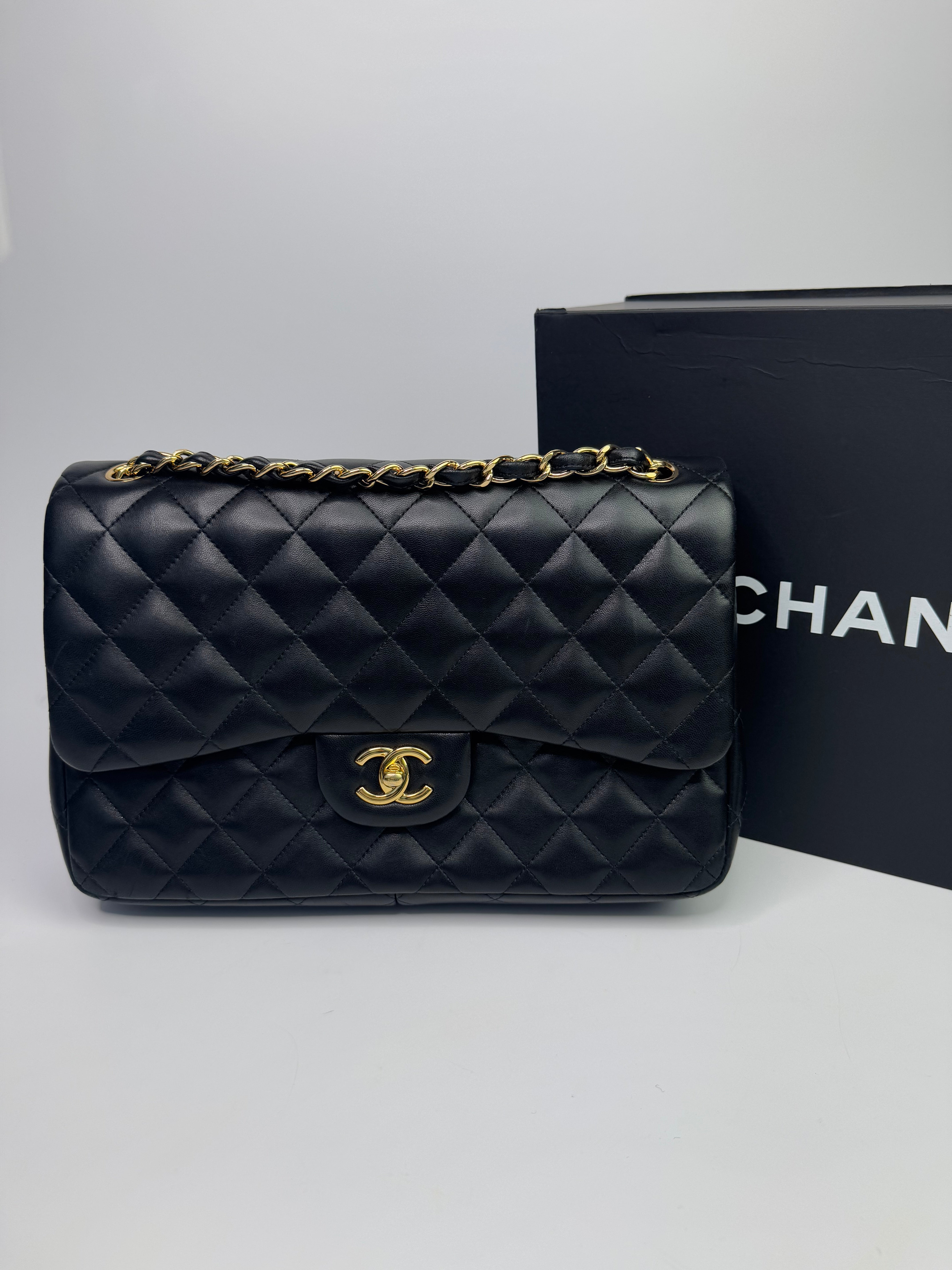 Authentic pre-loved Chanel Black Lambskin Leather Jumbo Classic Double Flap With Gold Hardware.