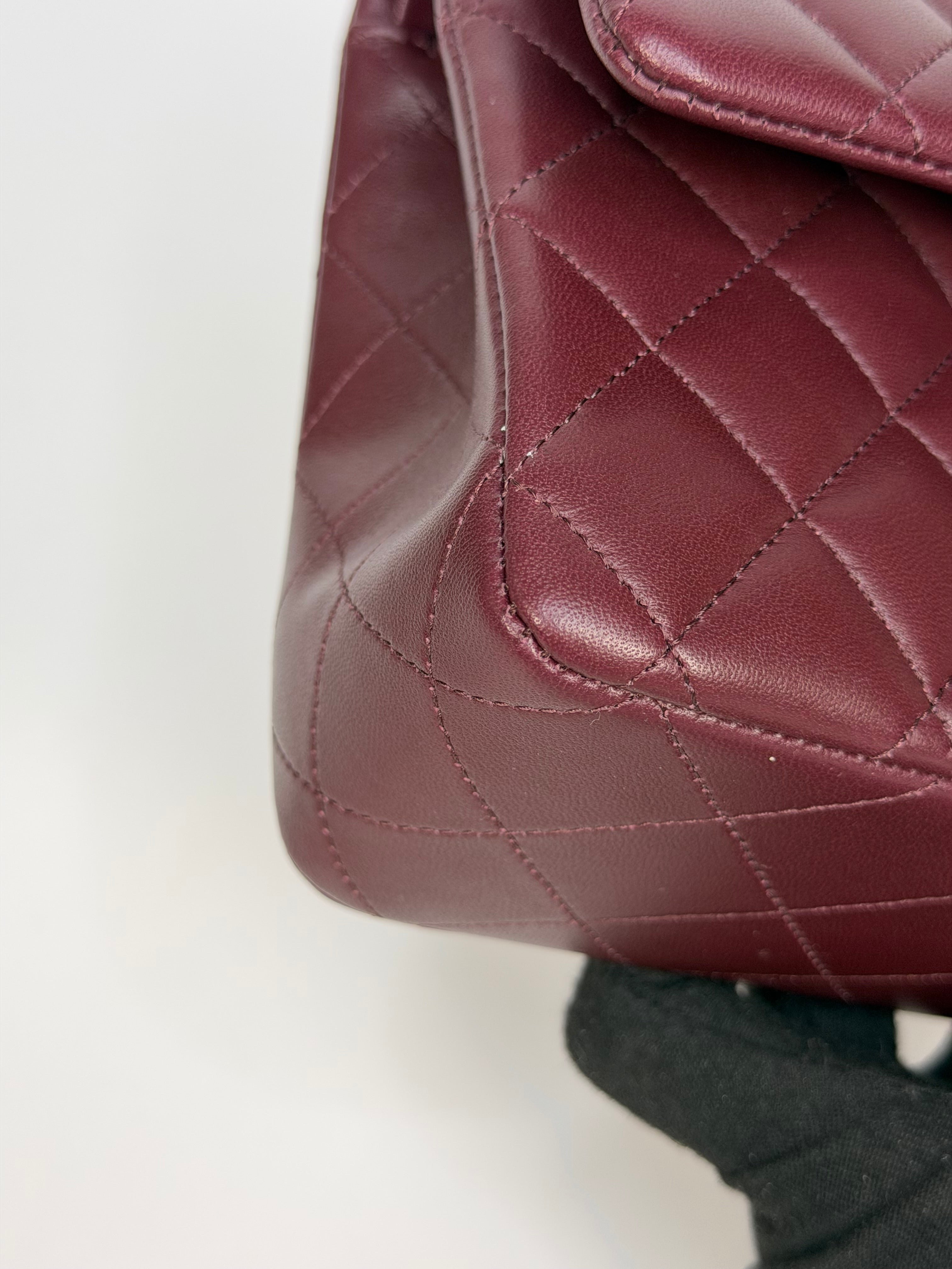 Chanel Medium Classic Double Flap Burgundy Lambskin Leather With Pale Gold Hardware. Authentic and preloved in excellent condition with 100% authenticity guarantee.