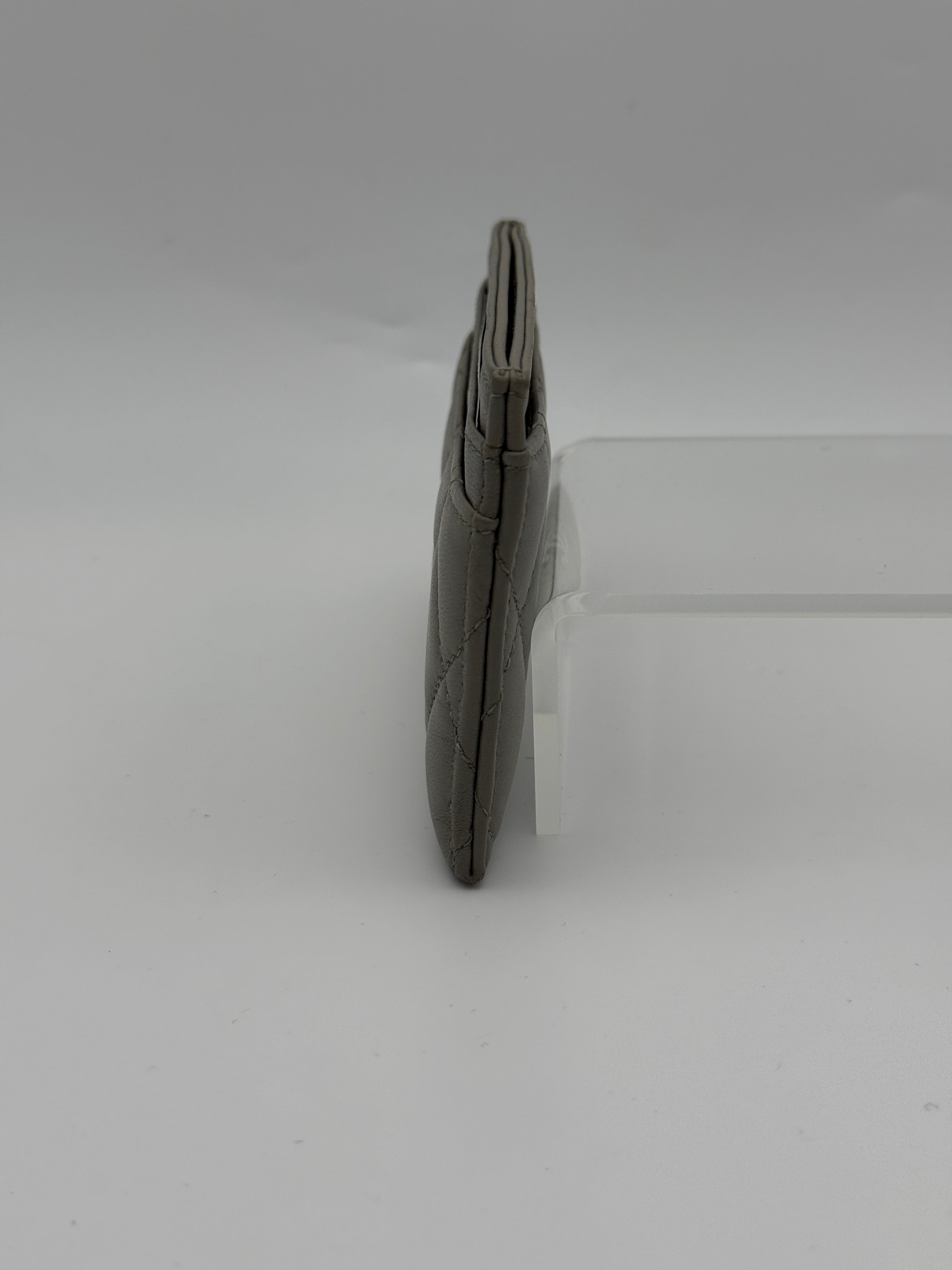 Authentic and pre loved Chanel Classic Card Holder In Grey Lambskin Leather With Silver hardware. Excellent Condition. 100% Authenticity guarantee.