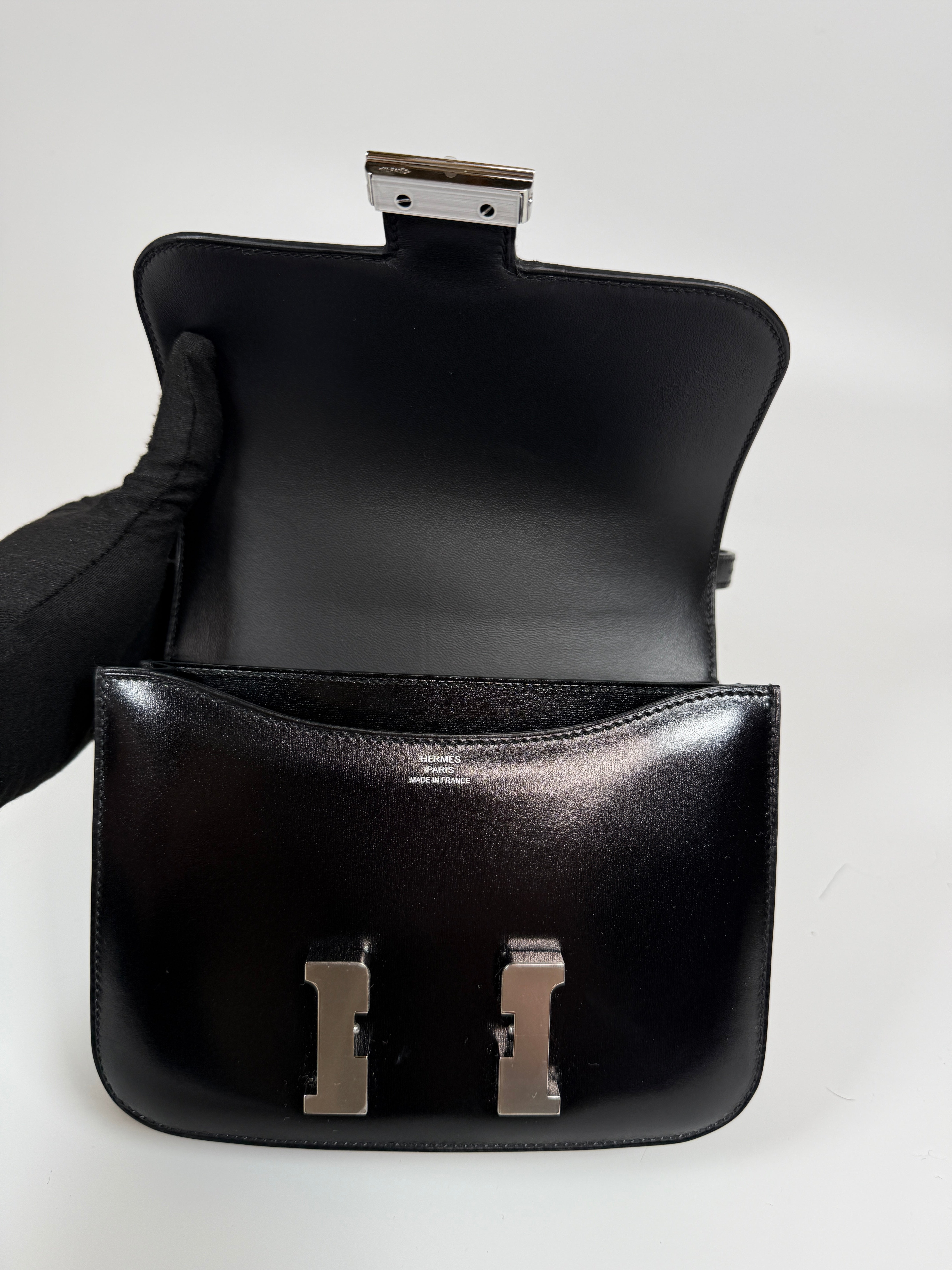Authentic and preloved Hermès Constance 18 In Black Box Leather With Palladium Hardware. 100% Authenticity guarantee.