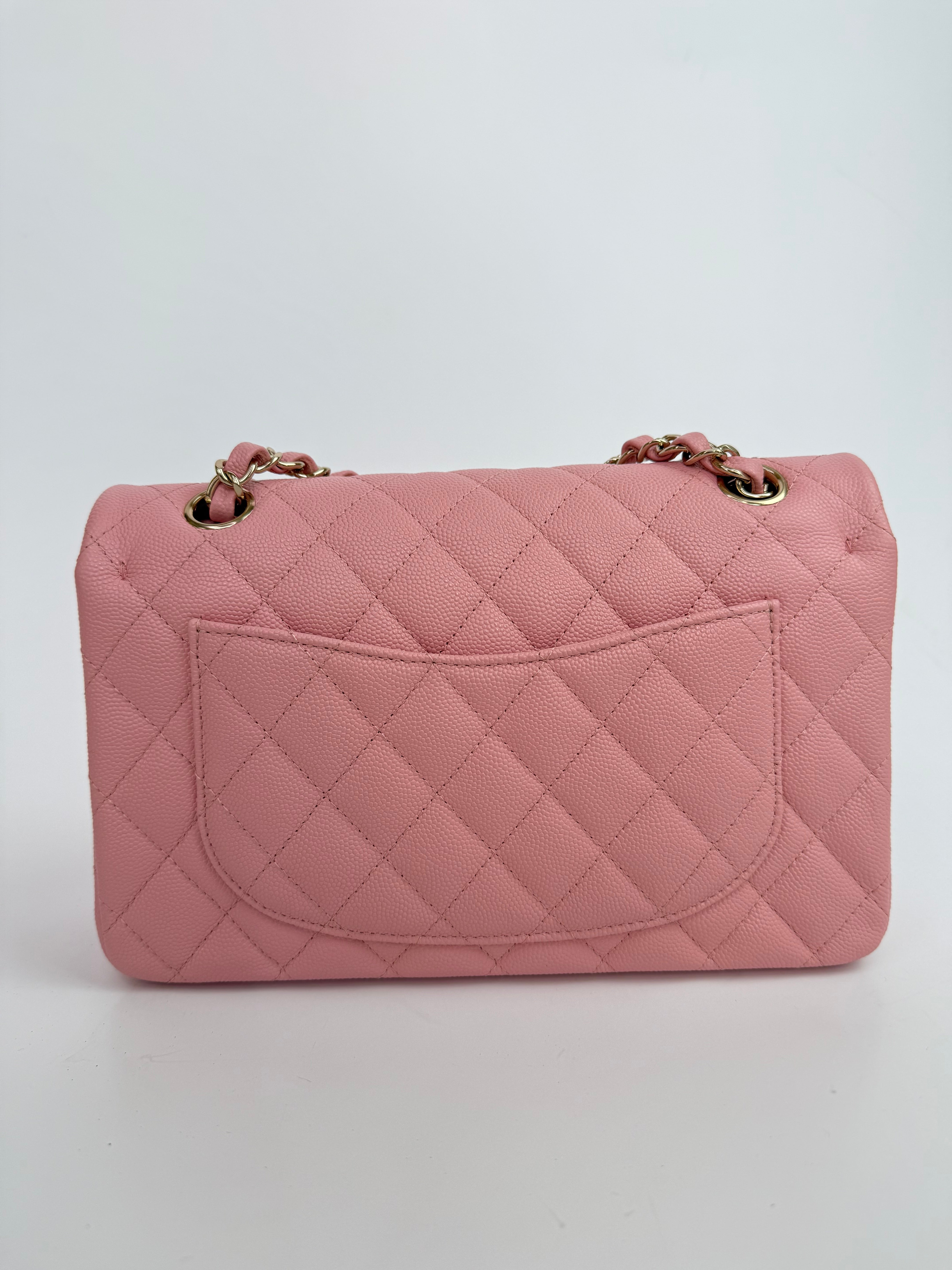 Authentic pre-loved Chanel Small Classic Double Flap In Pink Caviar Leather With Gold Hardware.