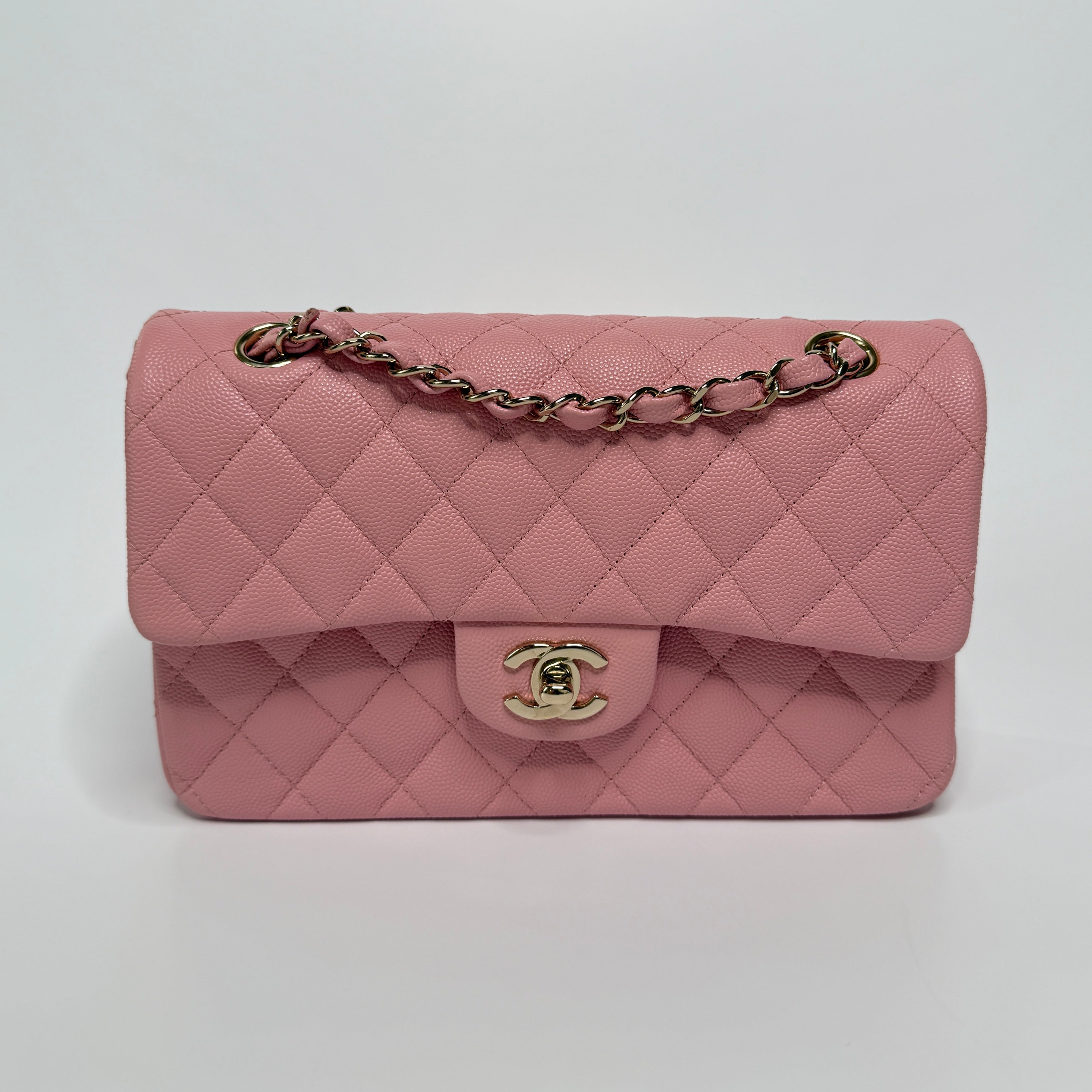 Authentic pre-loved Chanel Small Classic Double Flap In Pink Caviar Leather With Gold Hardware.