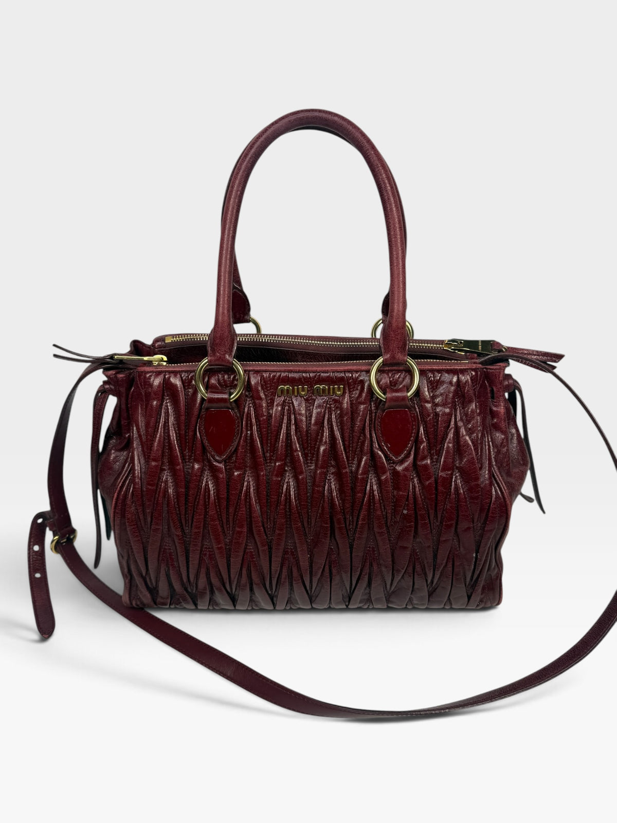 Miu Miu Bauletto Tote Bag In Burgundy Matelasse Leather With Gold Hardware. 100% authentic and pre loved in excellent condition.