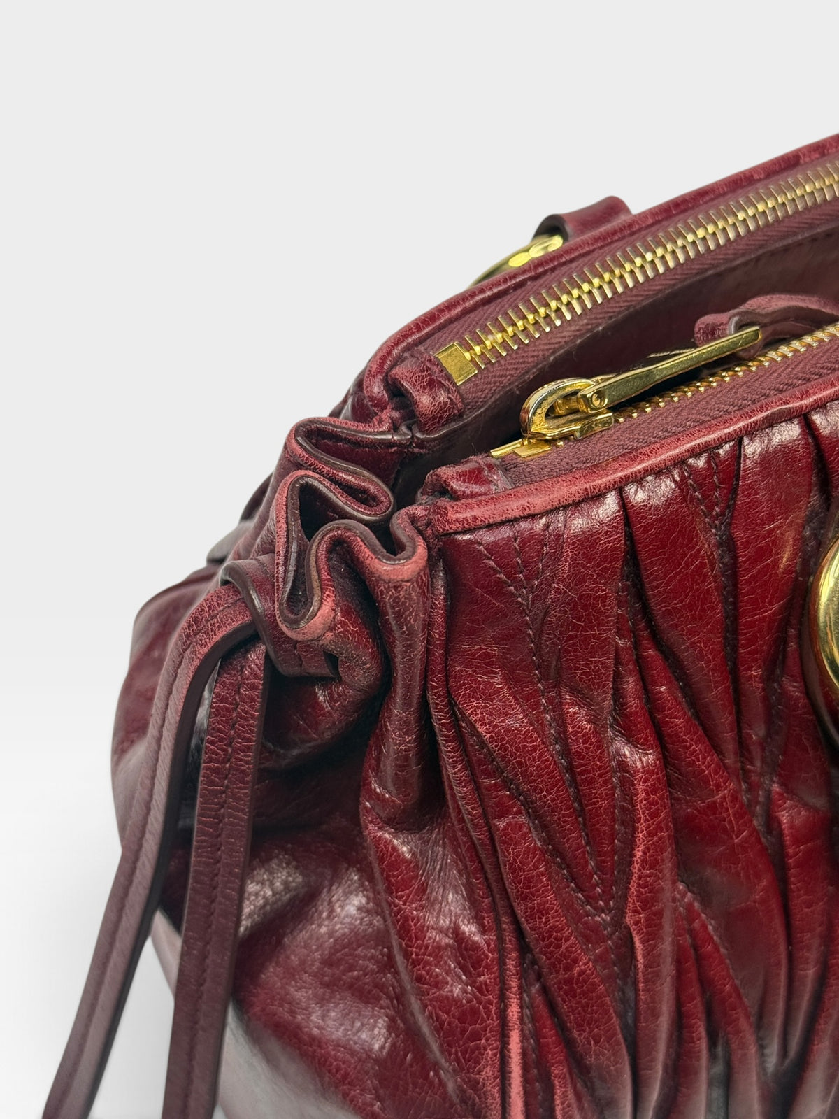 Miu Miu Bauletto Tote Bag In Burgundy Matelasse Leather With Gold Hardware. 100% authentic and pre loved in excellent condition.