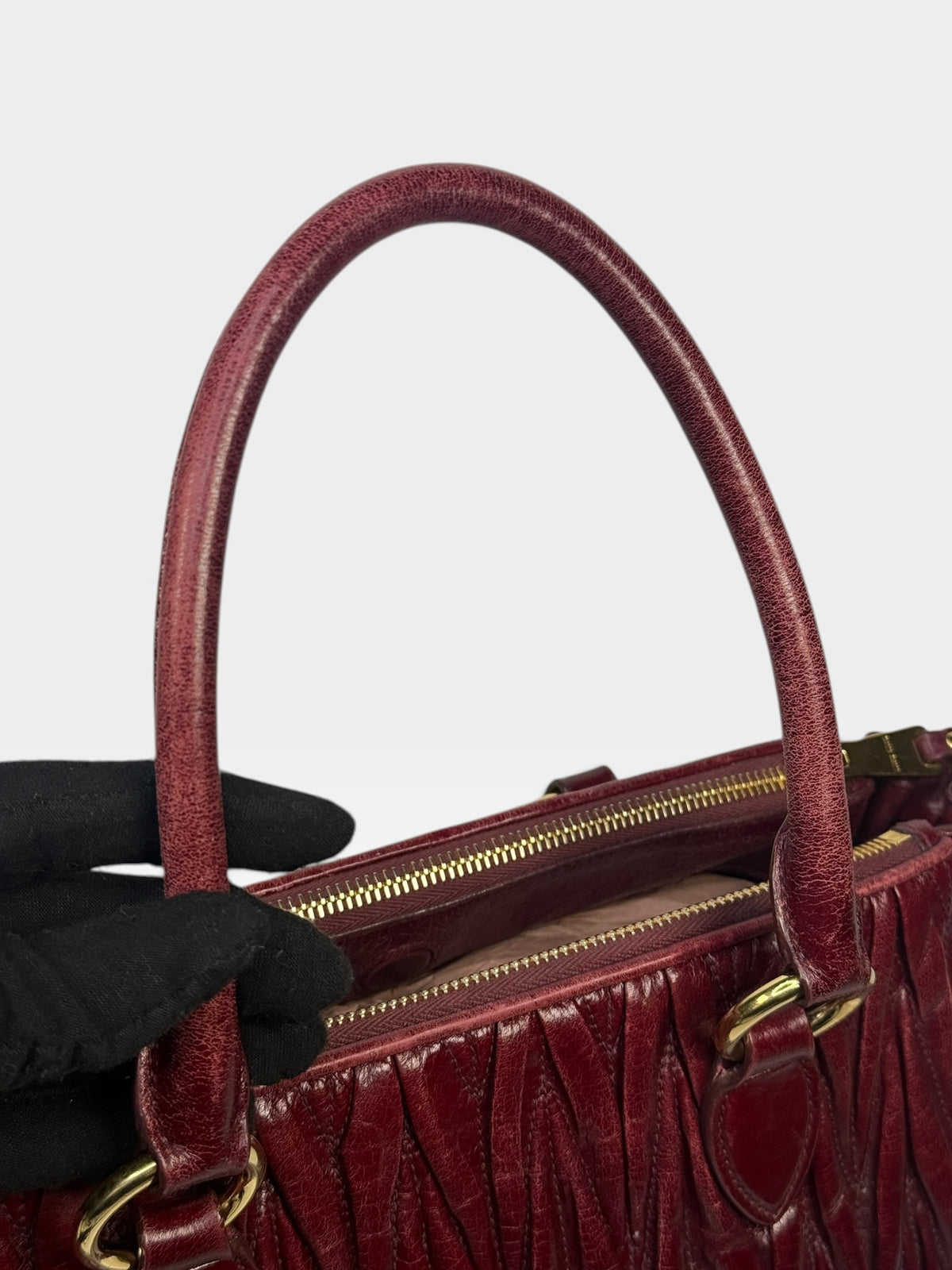 Miu Miu Bauletto Tote Bag In Burgundy Matelasse Leather With Gold Hardware. 100% authentic and pre loved in excellent condition.