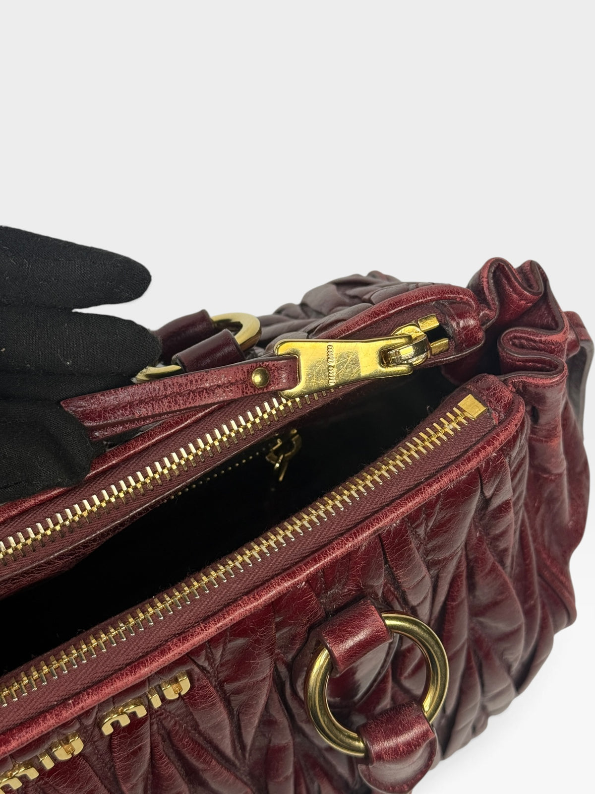 Miu Miu Bauletto Tote Bag In Burgundy Matelasse Leather With Gold Hardware. 100% authentic and pre loved in excellent condition.