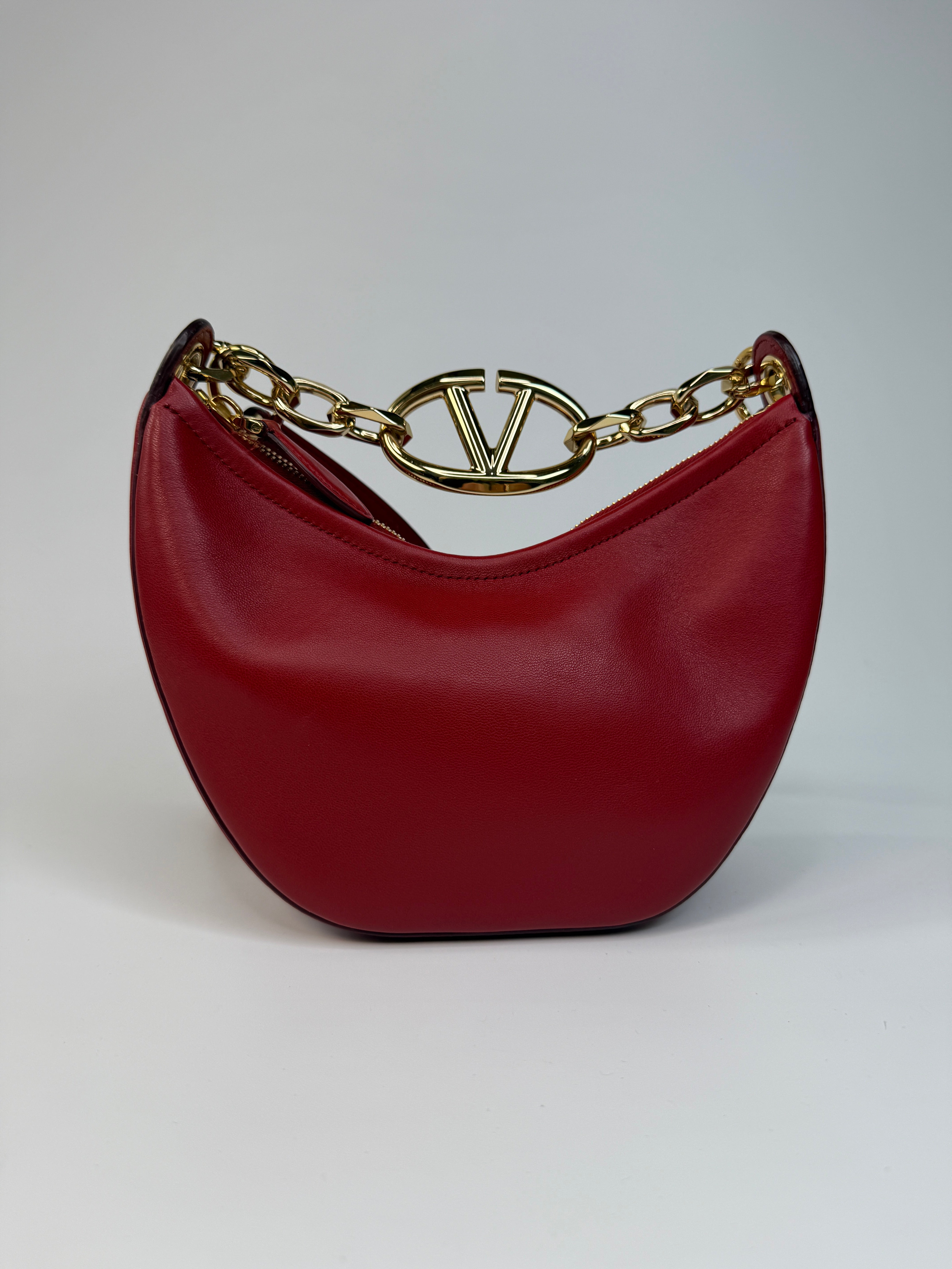 Authentic and preloved Valentino Garavani VLOGO Half Moon Bag  In Red Leather With Gold Hardware 
