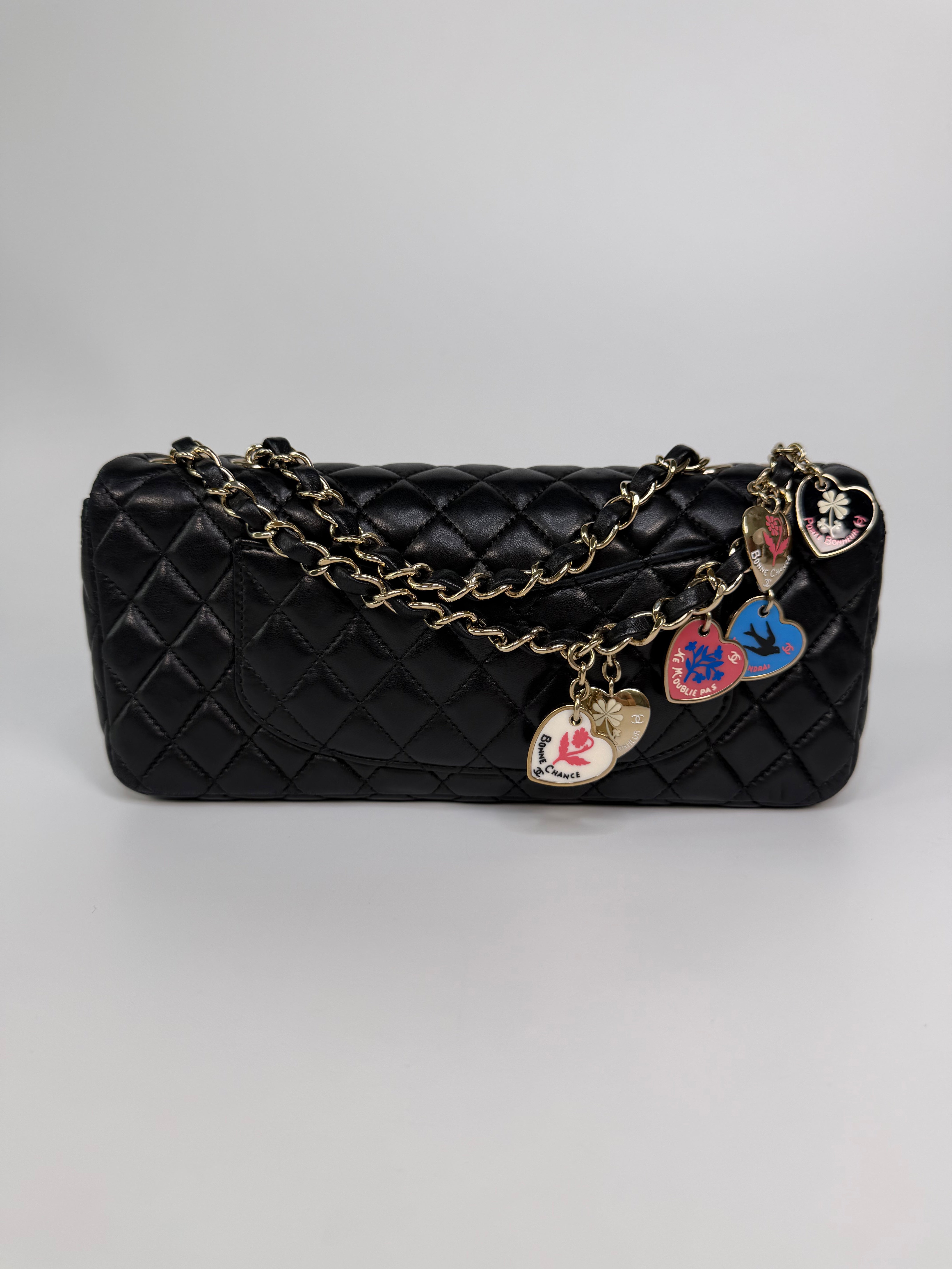 Chanel East West Charms Bag In Black Lambskin Leather With Gold Hardware. Authentic and preloved in excellent condition. 100% guarantee