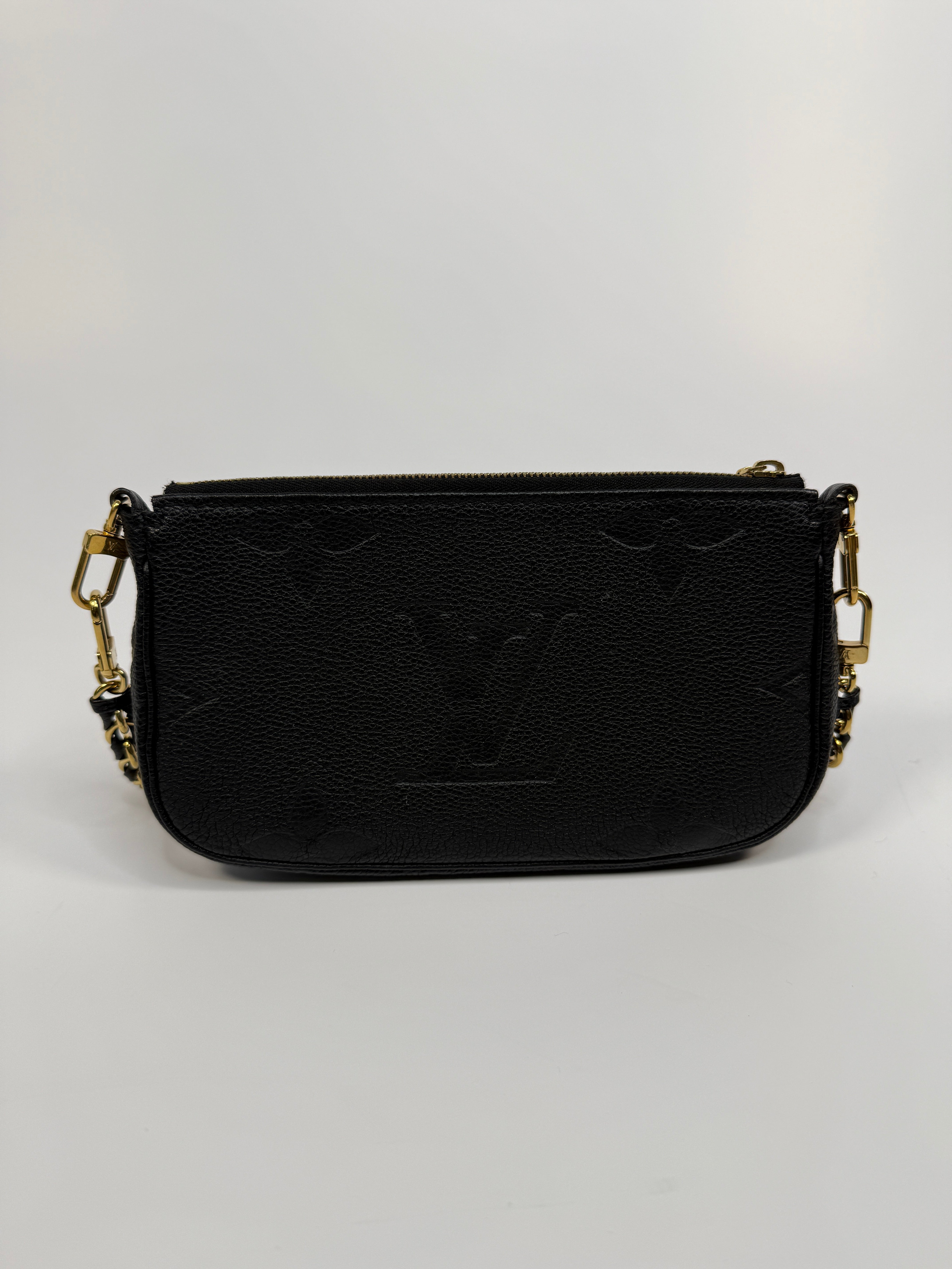 Black wallet with gold accents on a white background