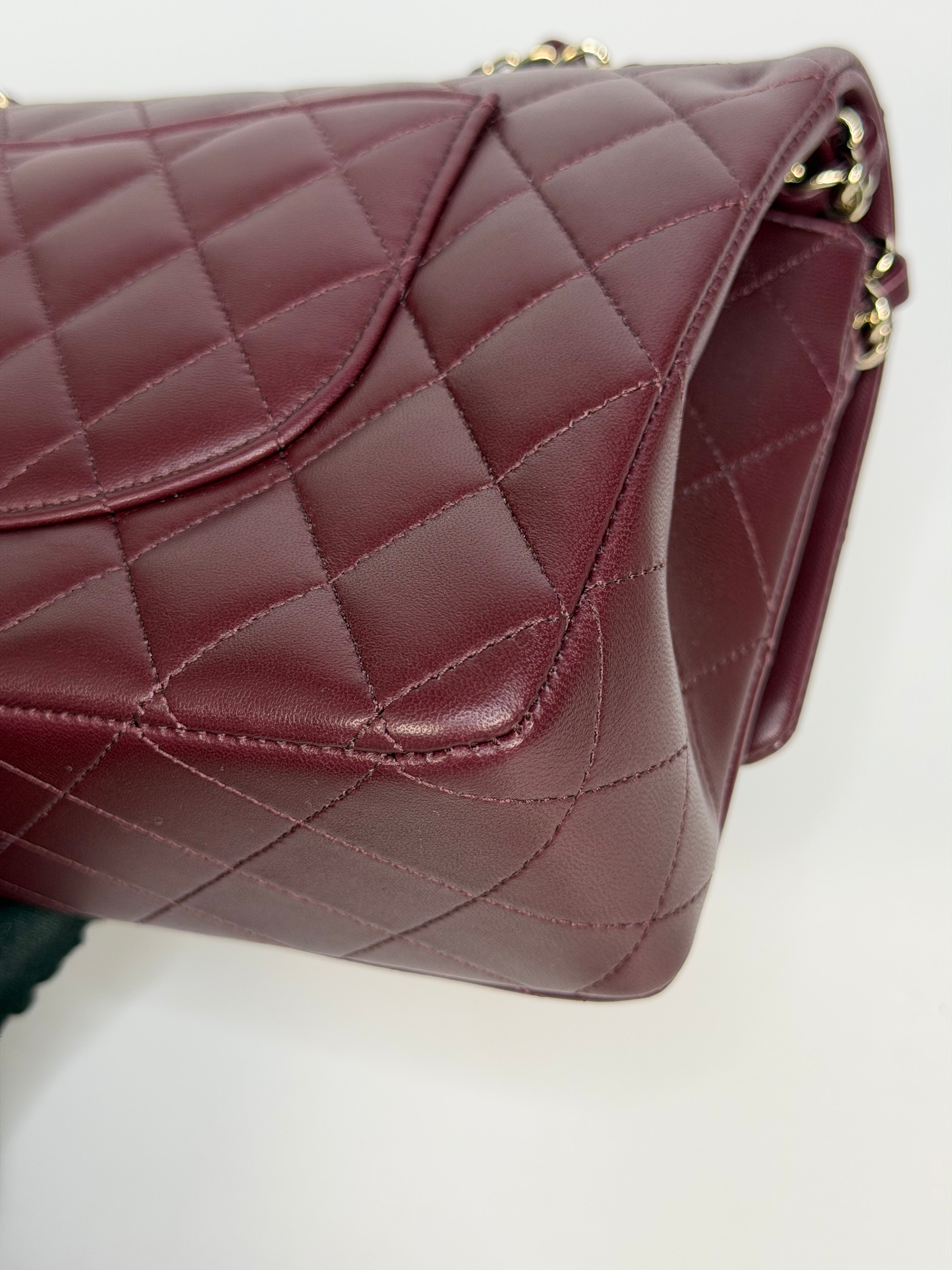 Chanel Medium Classic Double Flap Burgundy Lambskin Leather With Pale Gold Hardware. Authentic and preloved in excellent condition with 100% authenticity guarantee.