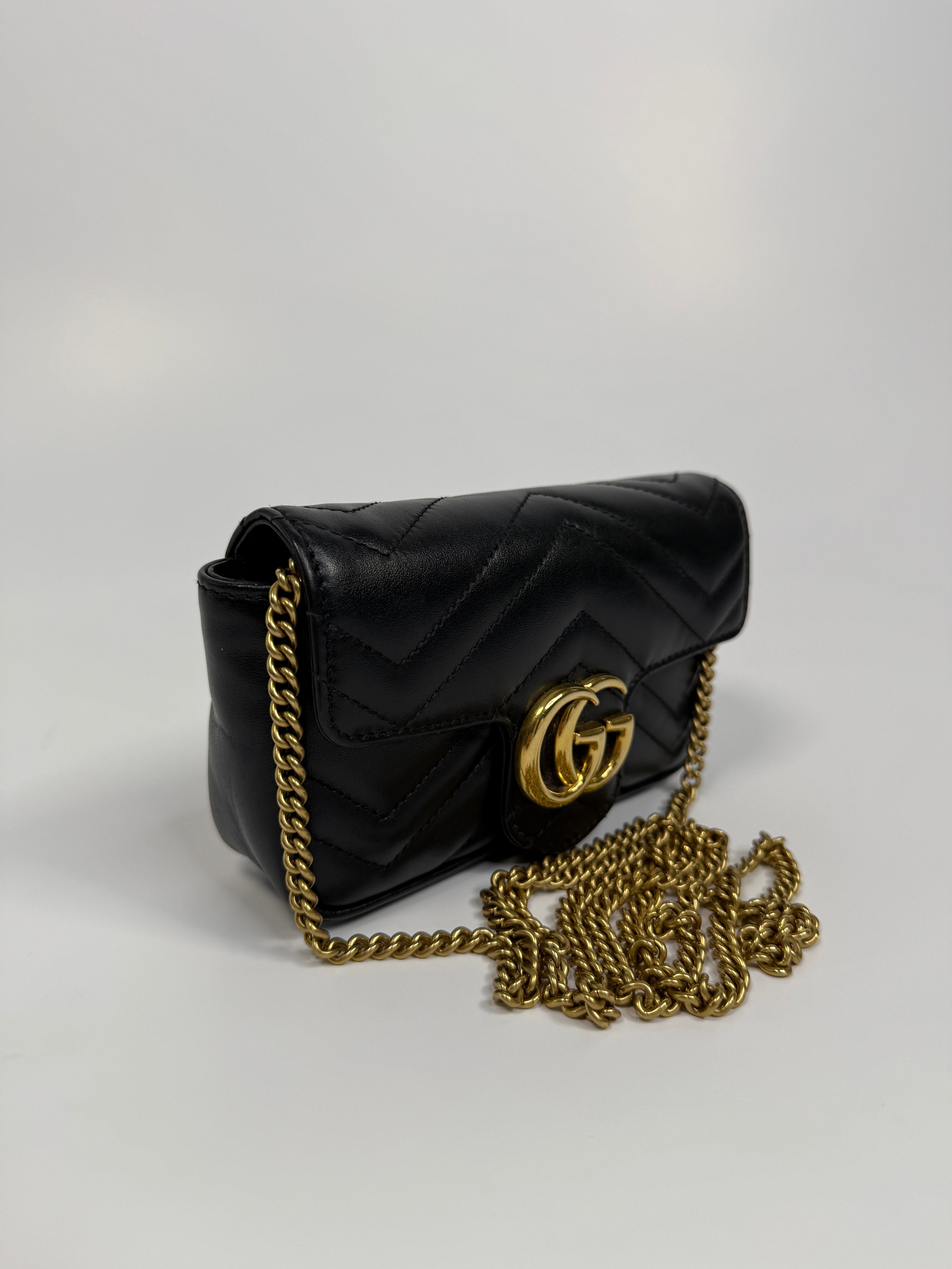 Authentic and preloved Gucci Marmont Matelassé Super Mini Bag In Black Leather With Gold Hardware in excellent condition 
