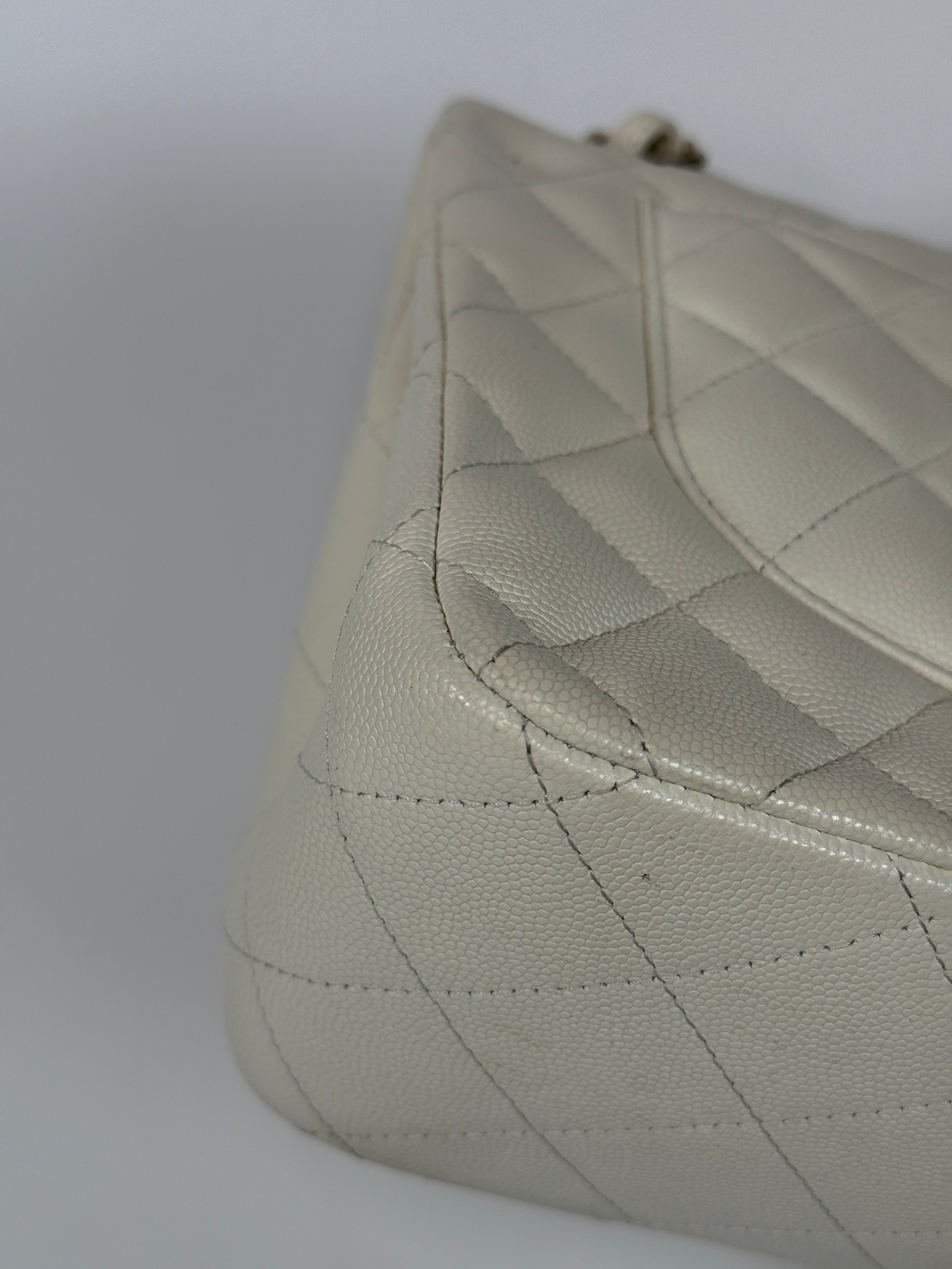 Authentic pre-loved Chanel Classic Jumbo Flap Bag In White Caviar Leather With pale gold  hardware in very good condition. Verified by Luxe Cheshire. International, fast  and fully insured delivery. Trusted designer resale.