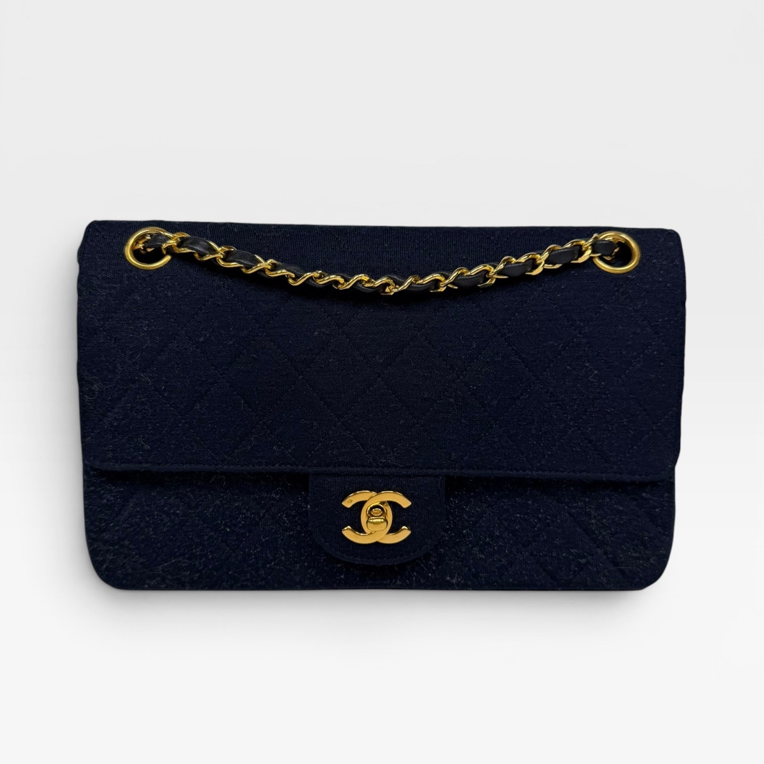 Chanel Vintage Medium Double Flap Navy Cotton With 24Kt Gold Hardware. Authentic and preloved in excellent condition.