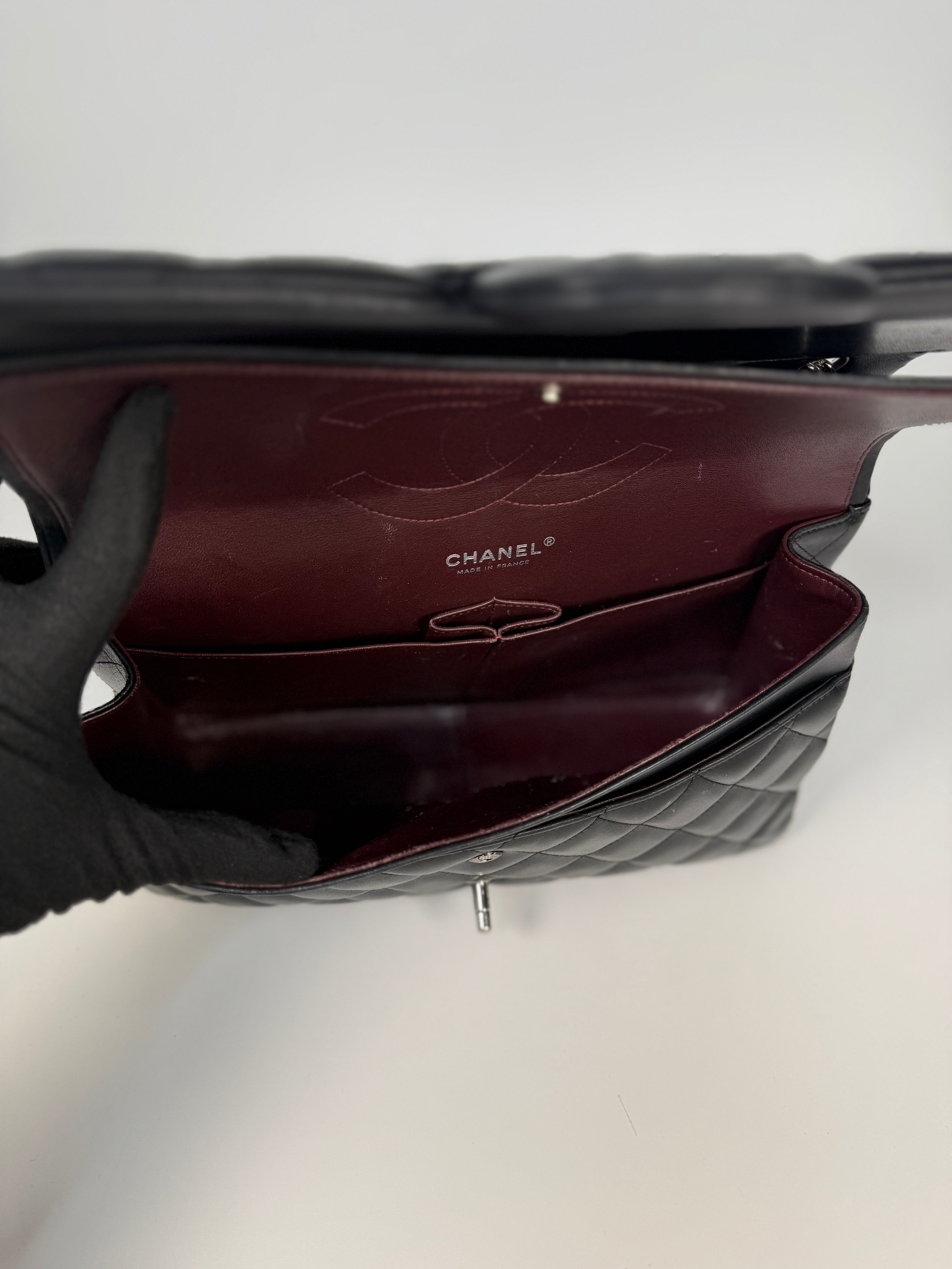 Authentic and preloved Chanel Jumbo Classic Flap Bag In Black Lambskin Leather With Silver hardware. Very Good condition. 100% Authenticity guarantee 