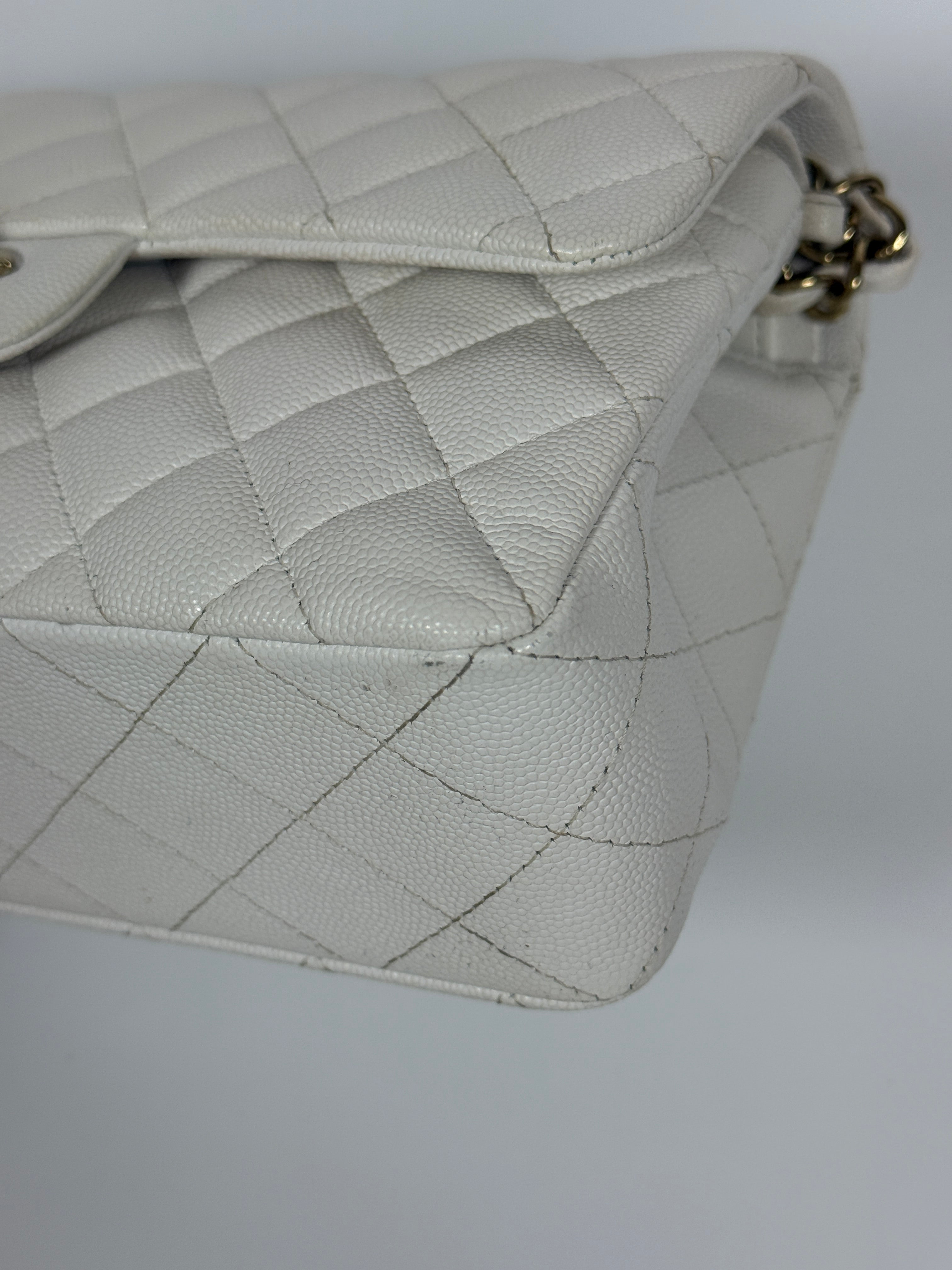 Authentic and preloved Chanel Small Classic Double Flap In White Caviar Leather With pale gold hardware. Very Good Condition. 100% Authenticity guarantee 